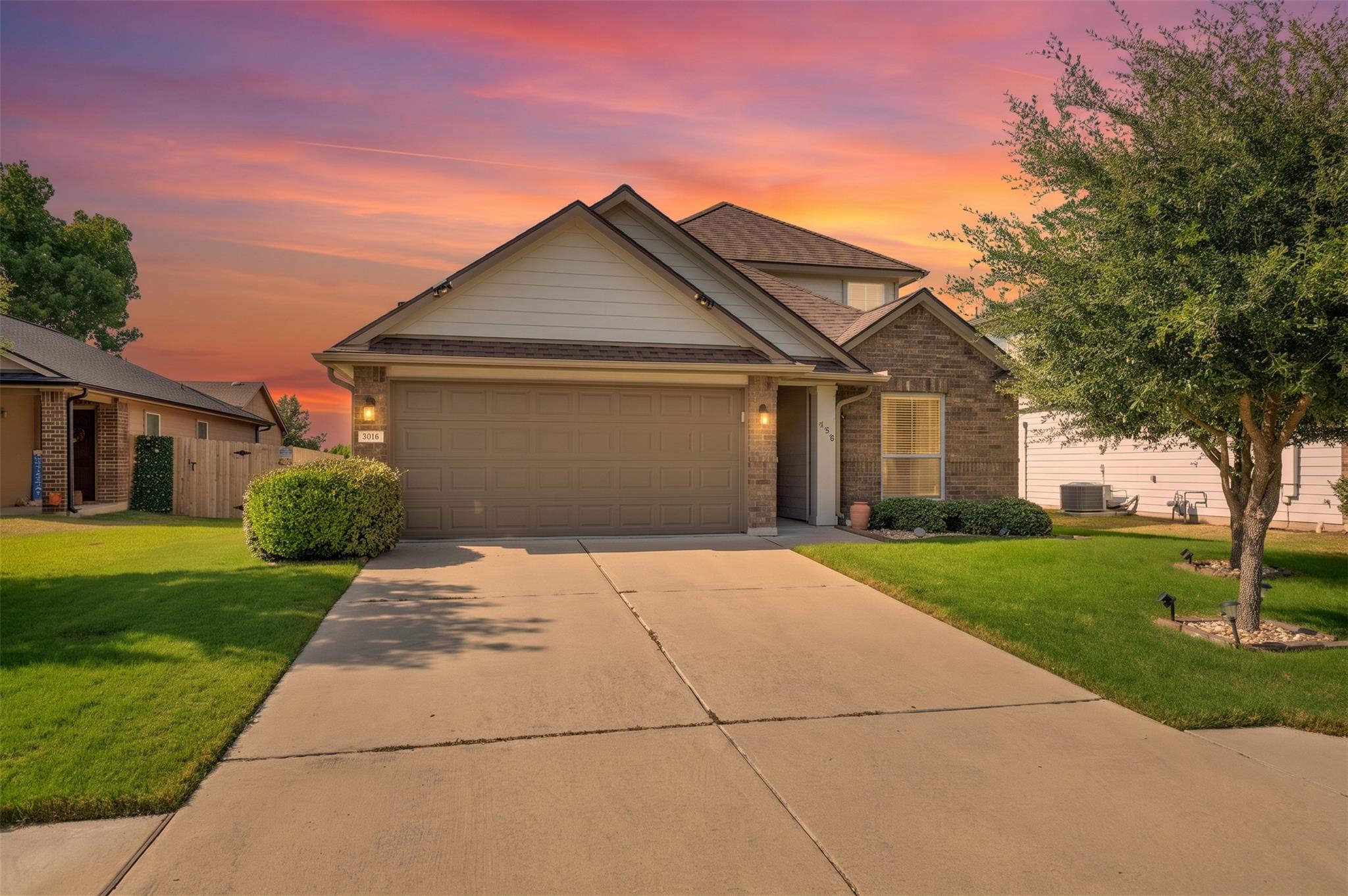 A spacious concrete driveway leads directly to a 