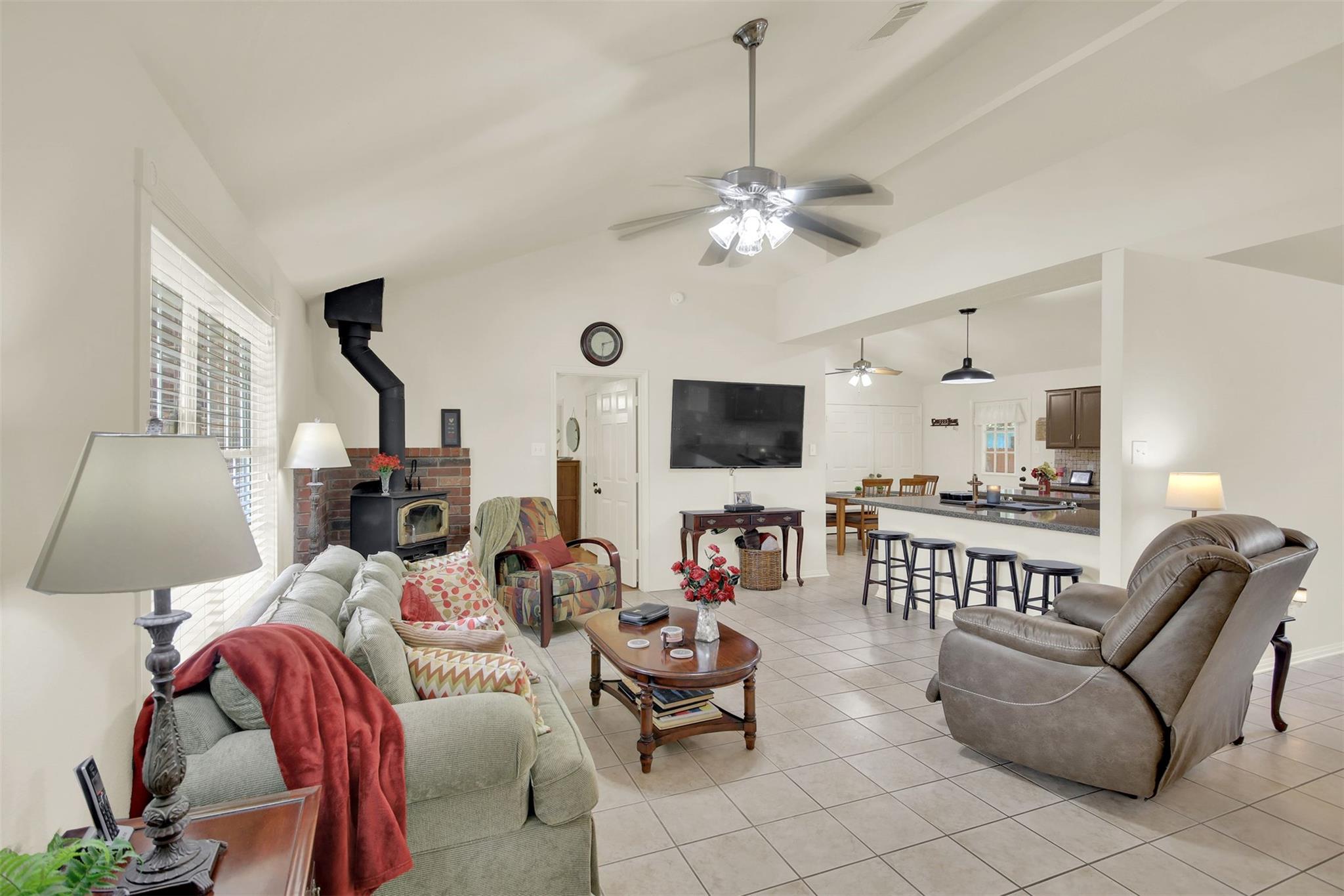 Vaulted ceilings and tile flooring enhance this o