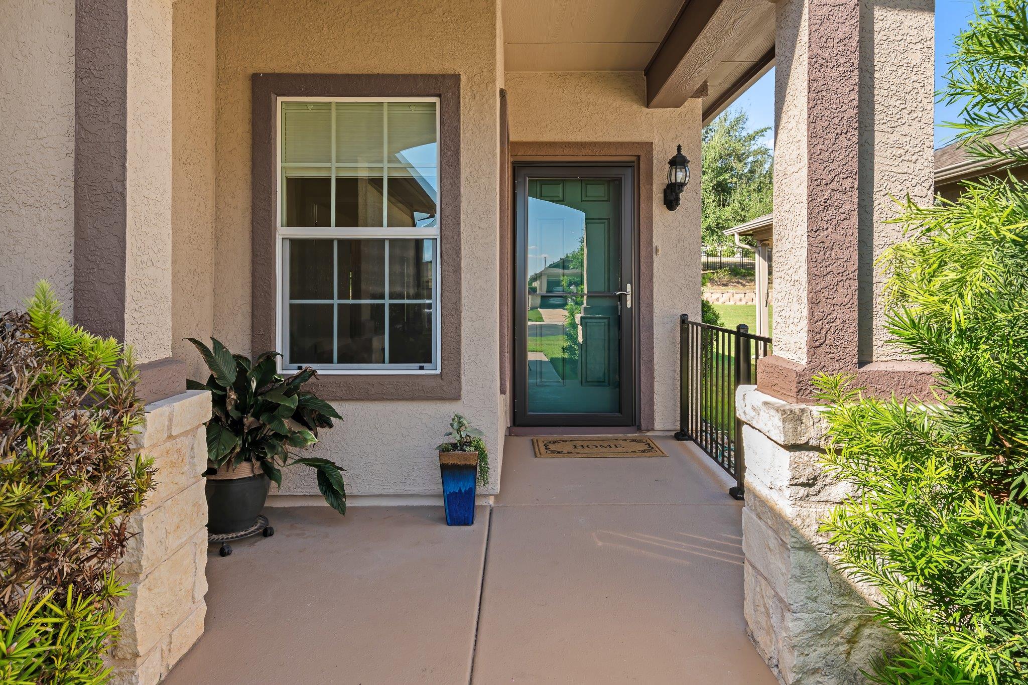Welcoming front porch features stone-wrapped colu