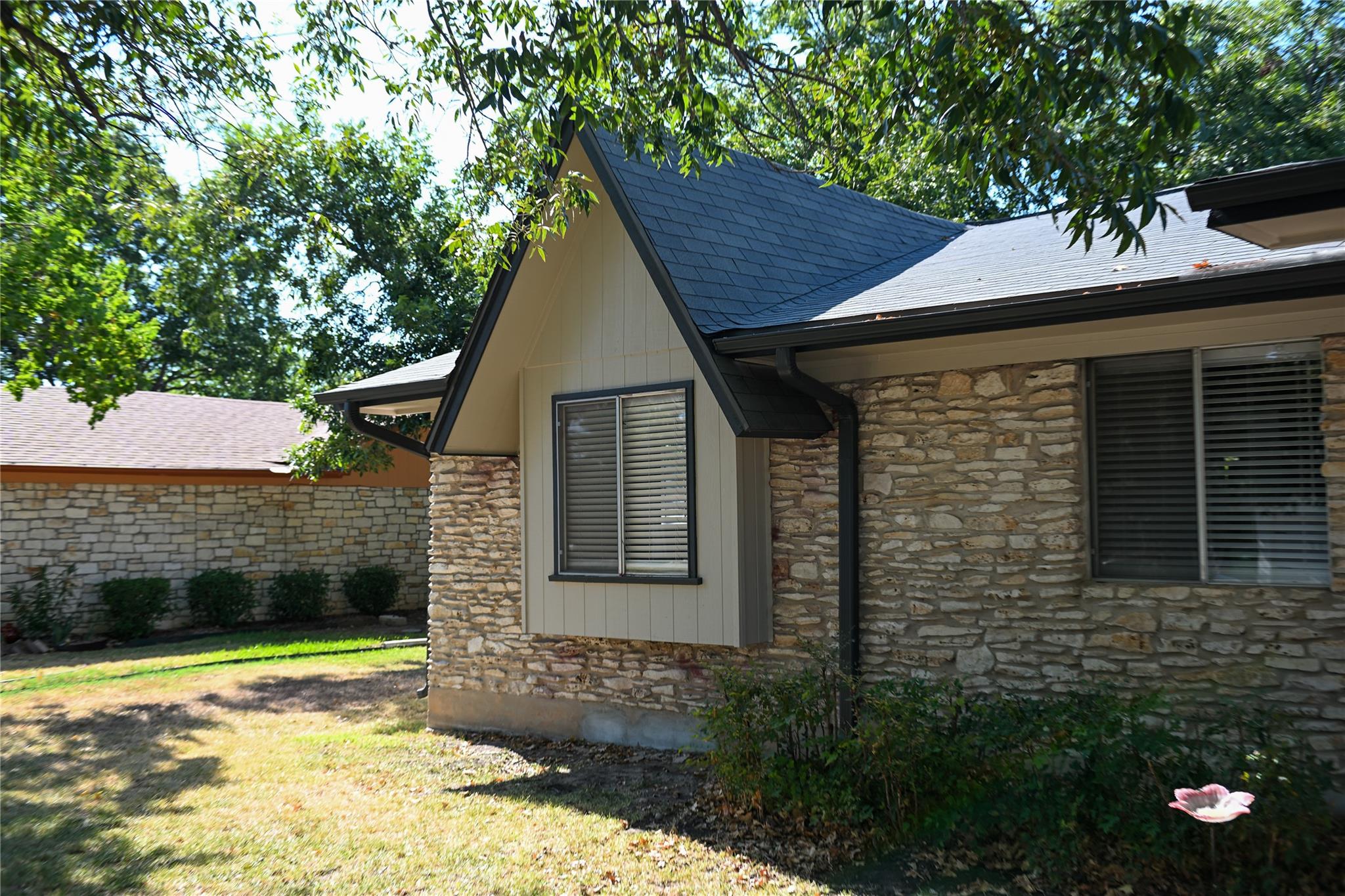 Natural stone masonry and a steep gabled roofline