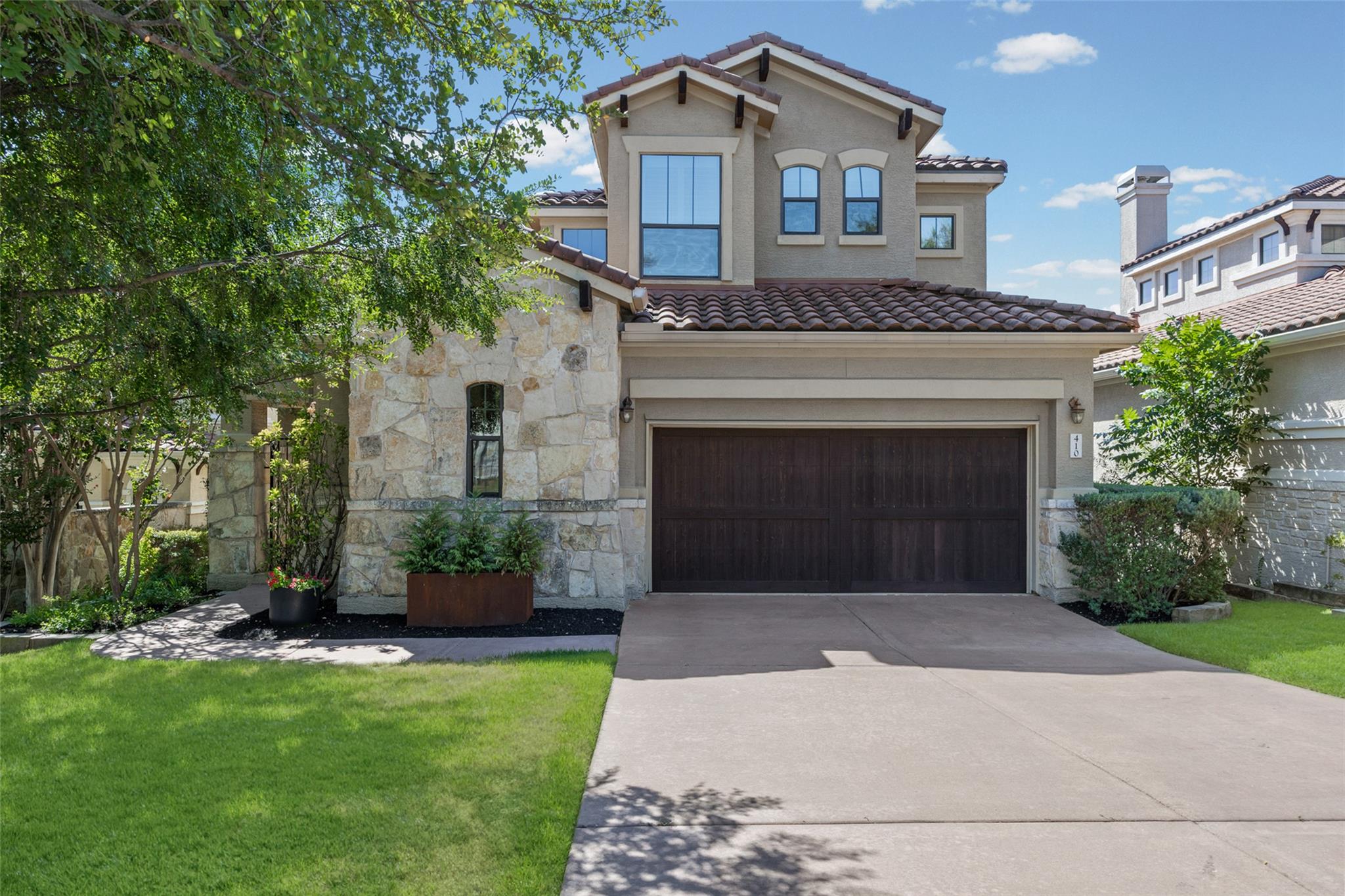 Stone and stucco accents define this elegant mult
