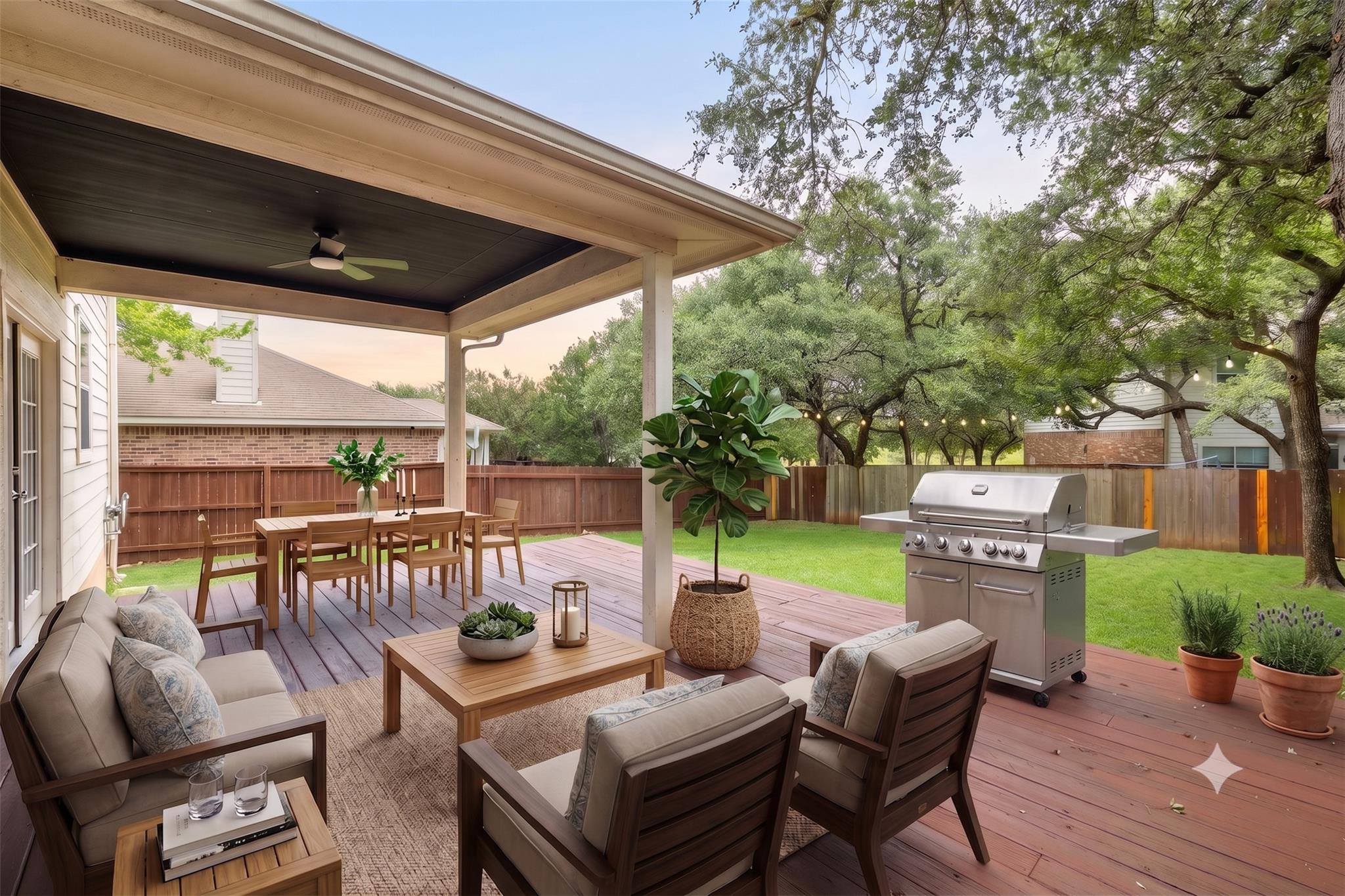 Mature trees frame a spacious wooden deck with a 