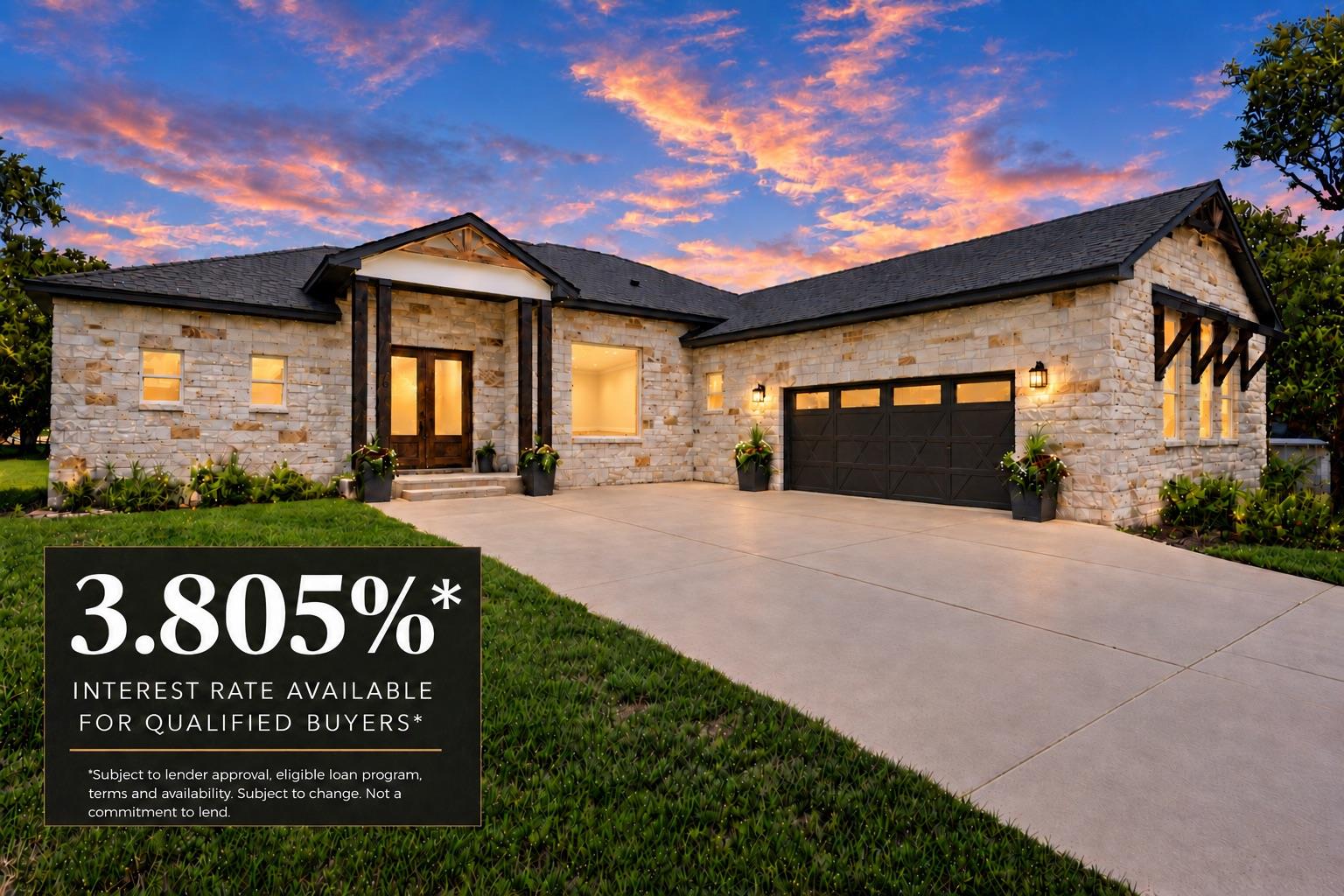 A spacious driveway leads to this modern stone ex