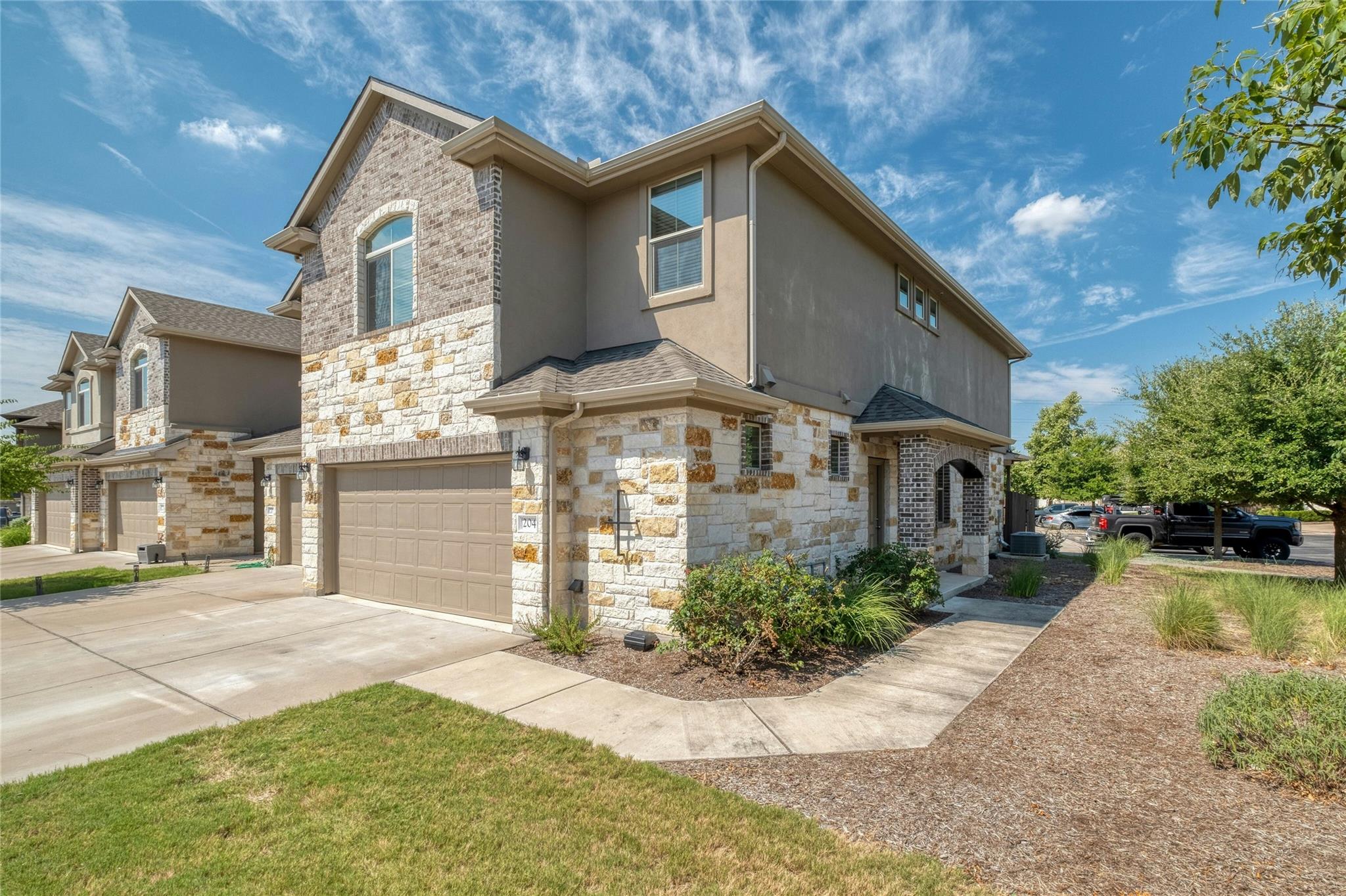 Textured stone facade highlights this modern mult