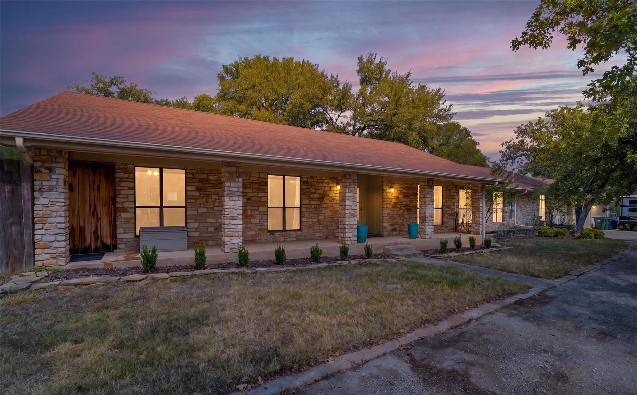 Natural stone columns and a deep covered porch hi