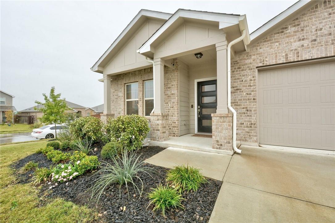 A welcoming front porch and manicured landscaping
