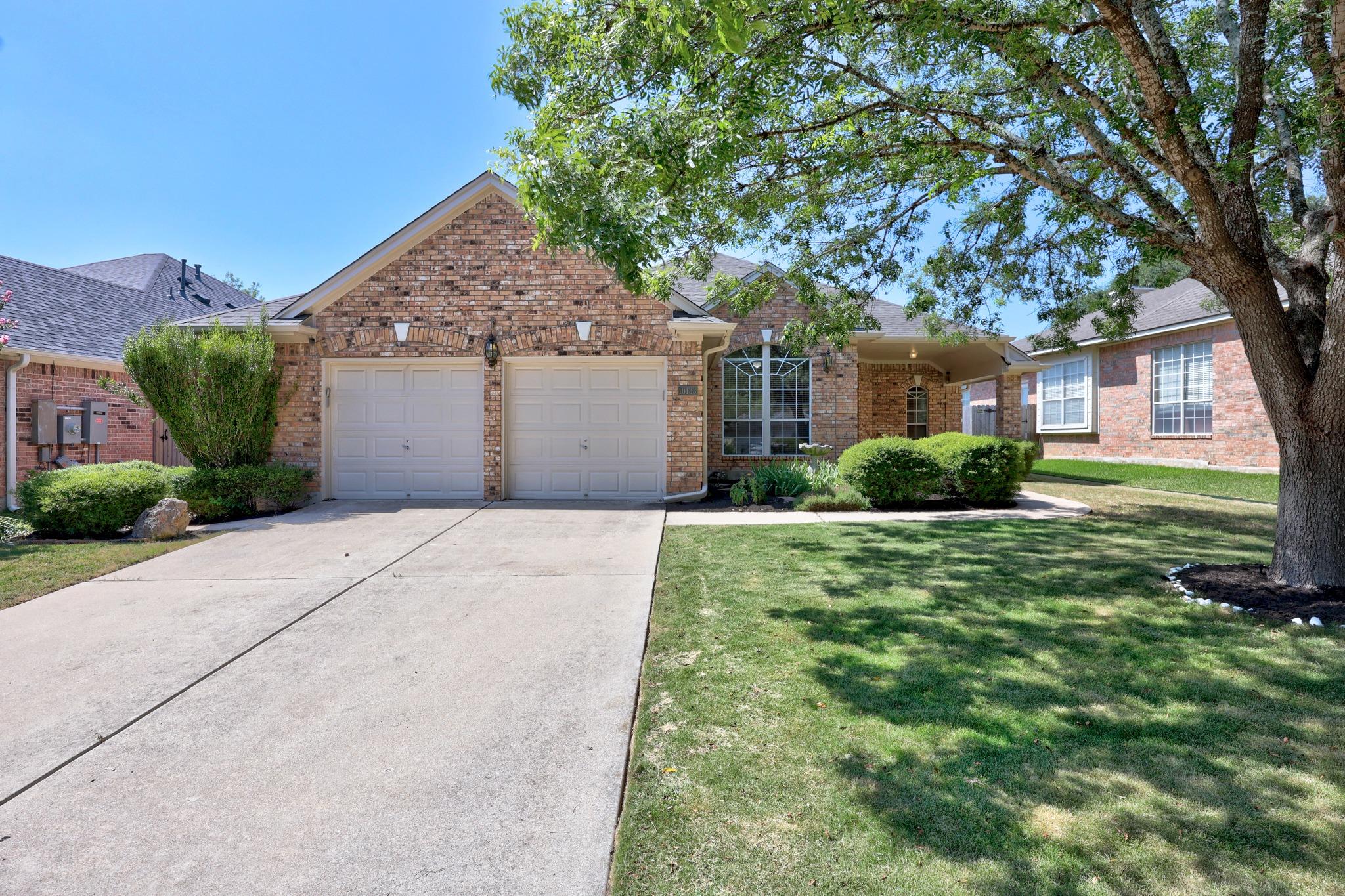 A classic brick exterior and a concrete driveway 