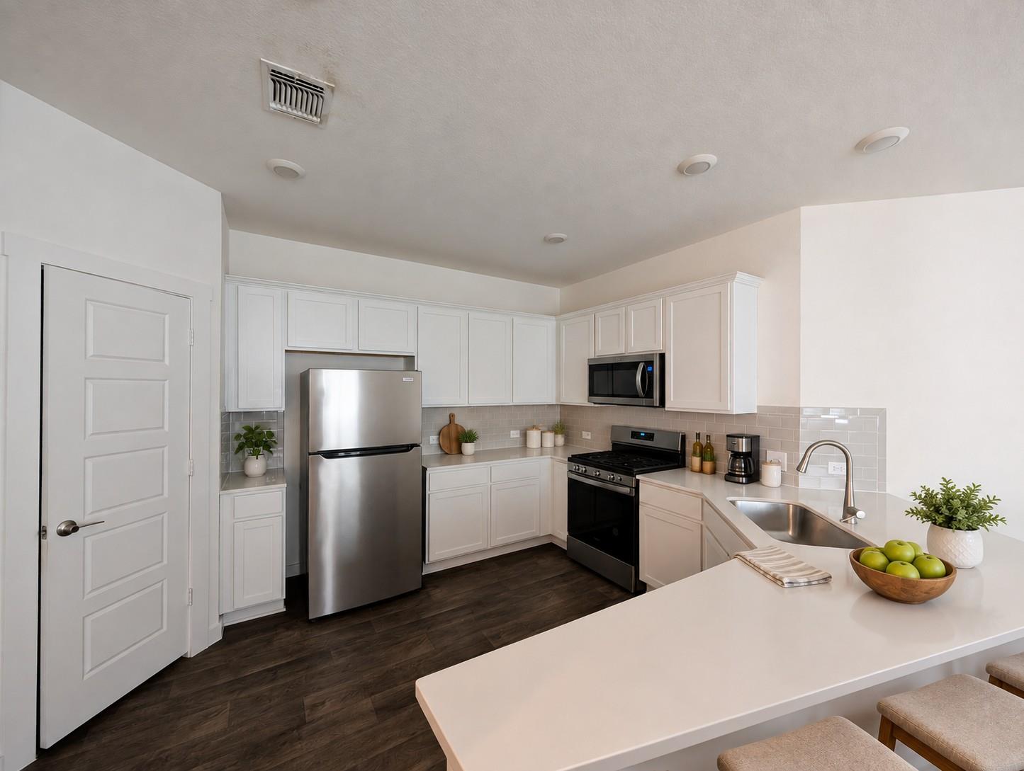 Gleaming stone countertops and stainless steel ap