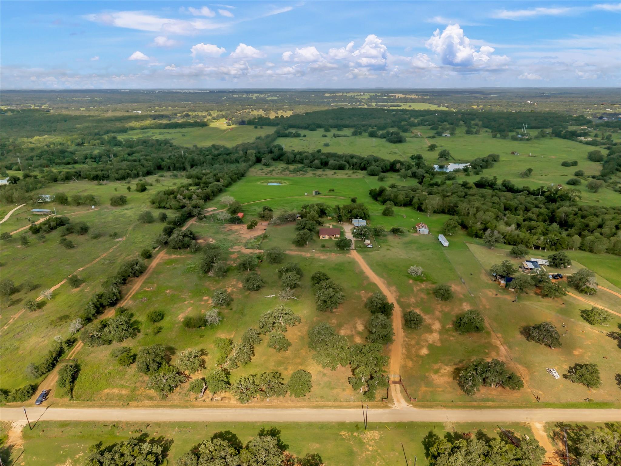 A vast expanse of green pastureland features matu