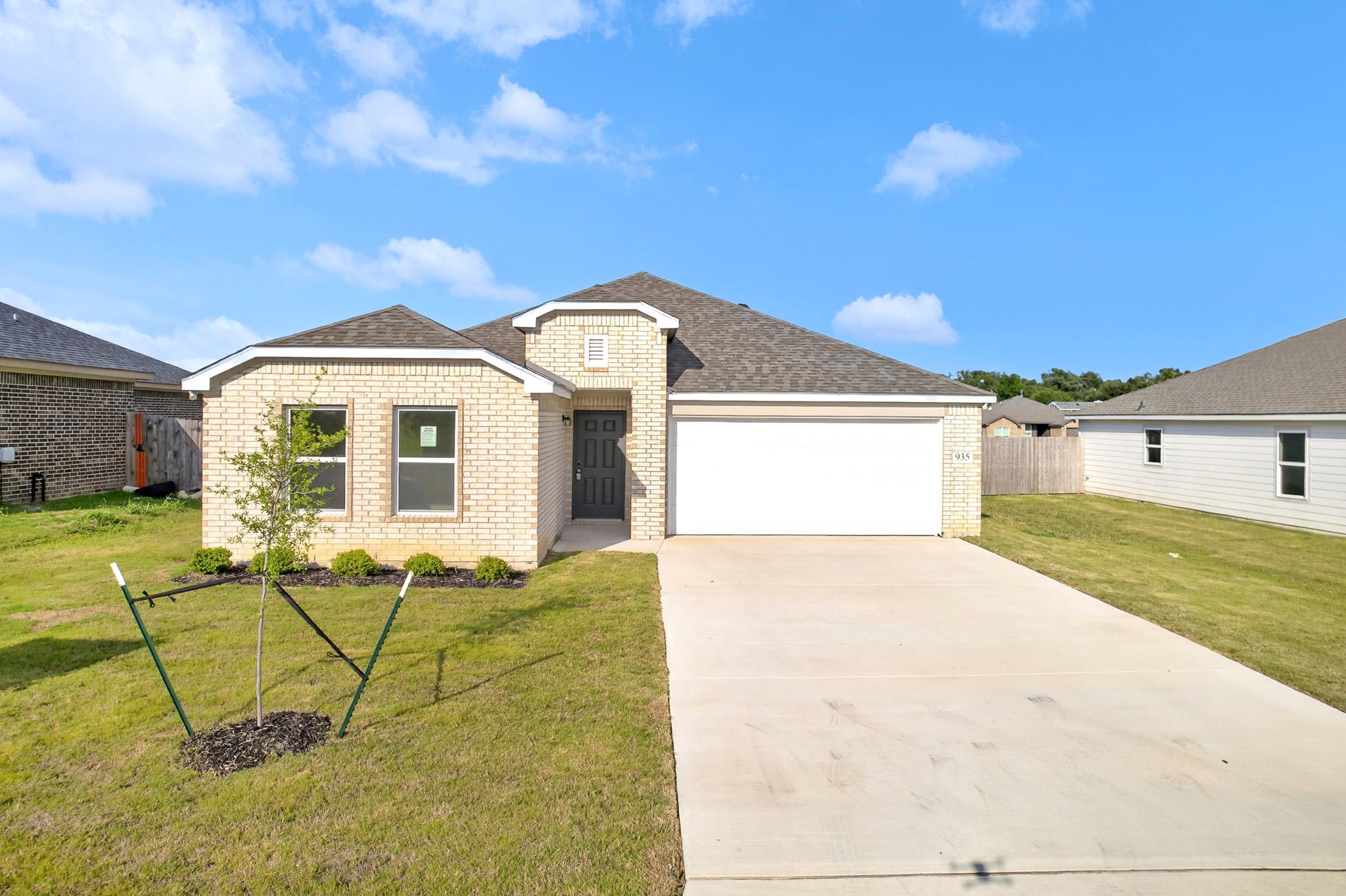 A classic brick exterior and concrete driveway de