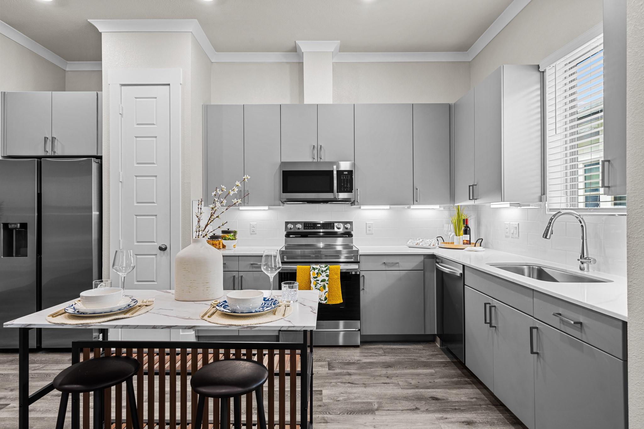 Modern cabinetry and stone countertops elevate th