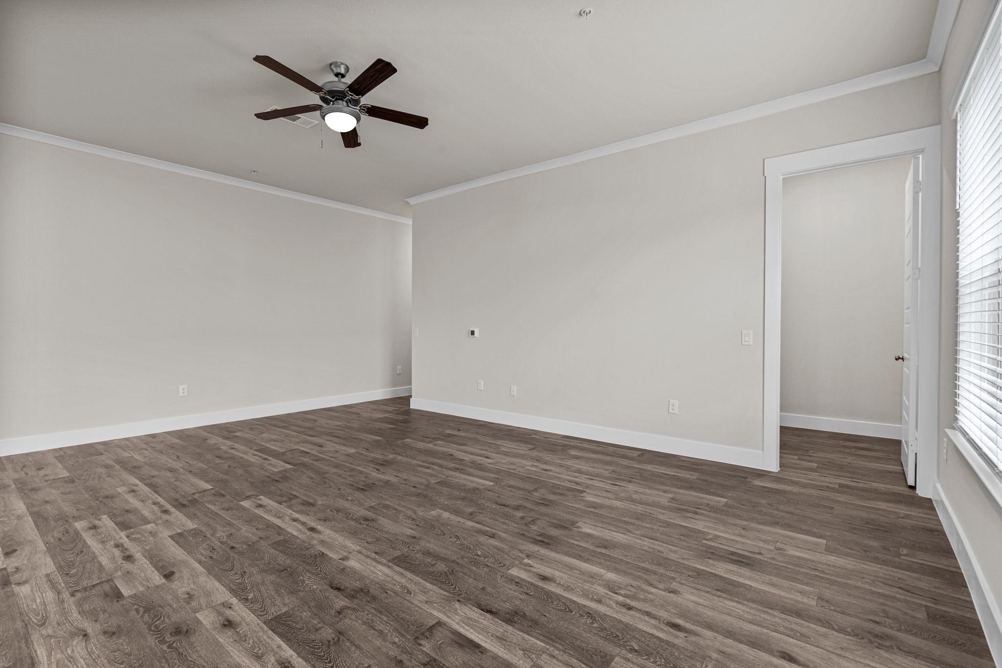 Rich wood-look flooring and crisp crown molding c