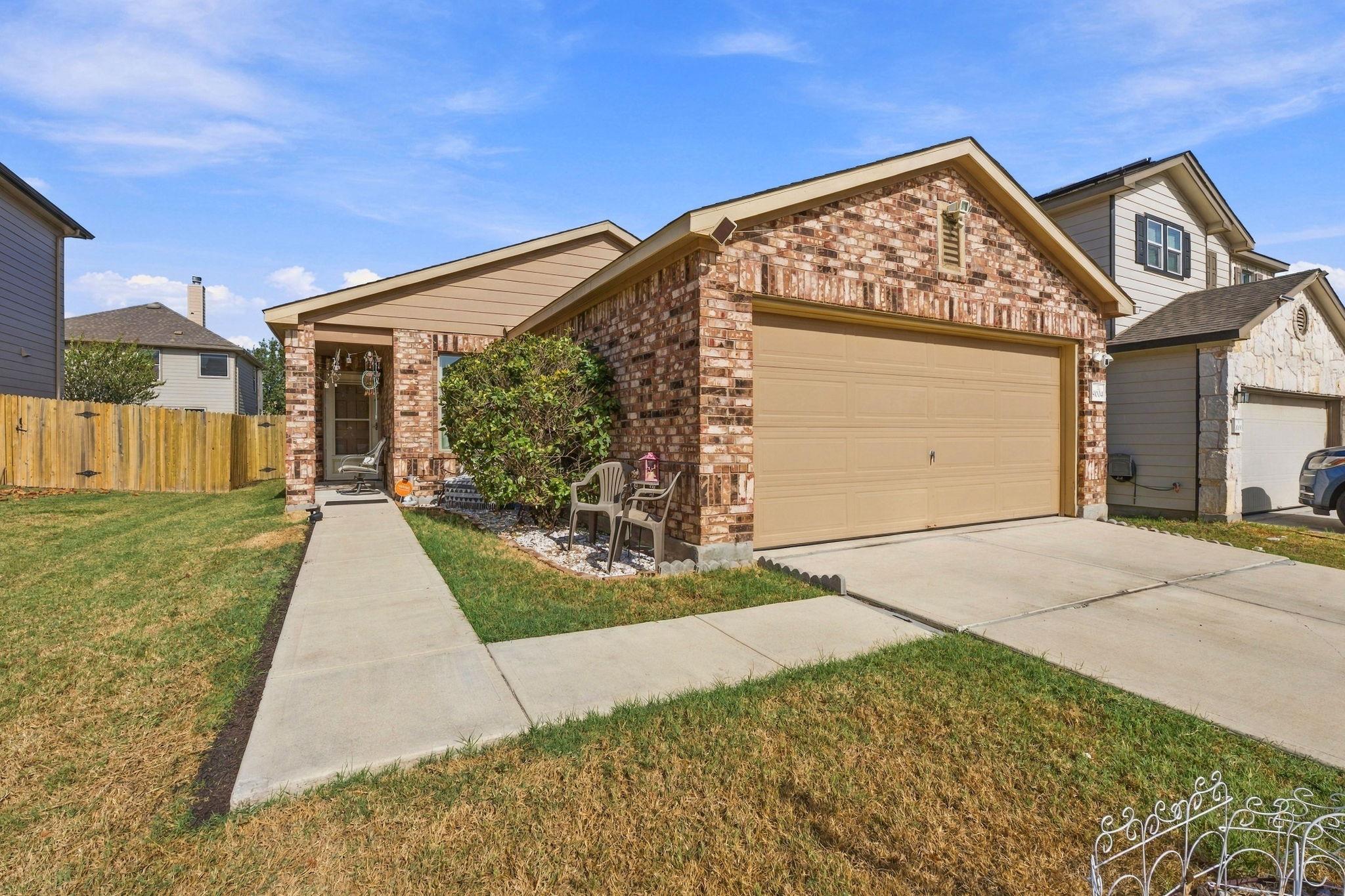 Classic brick accents and a two-car garage define