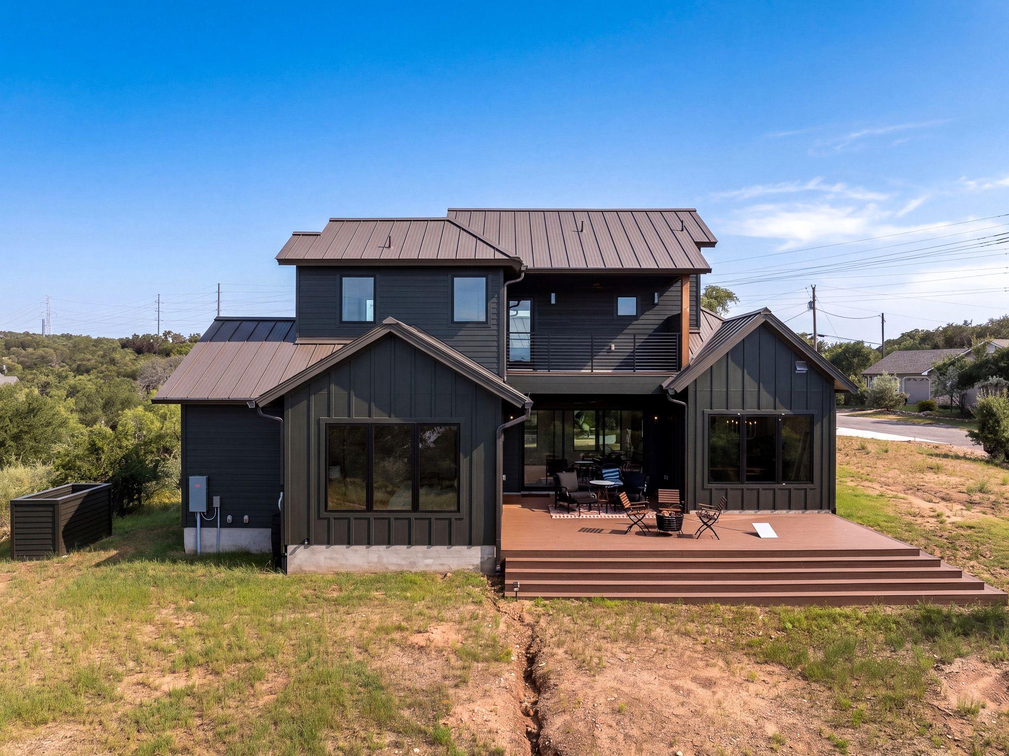 An expansive multi-level deck extends from the ba
