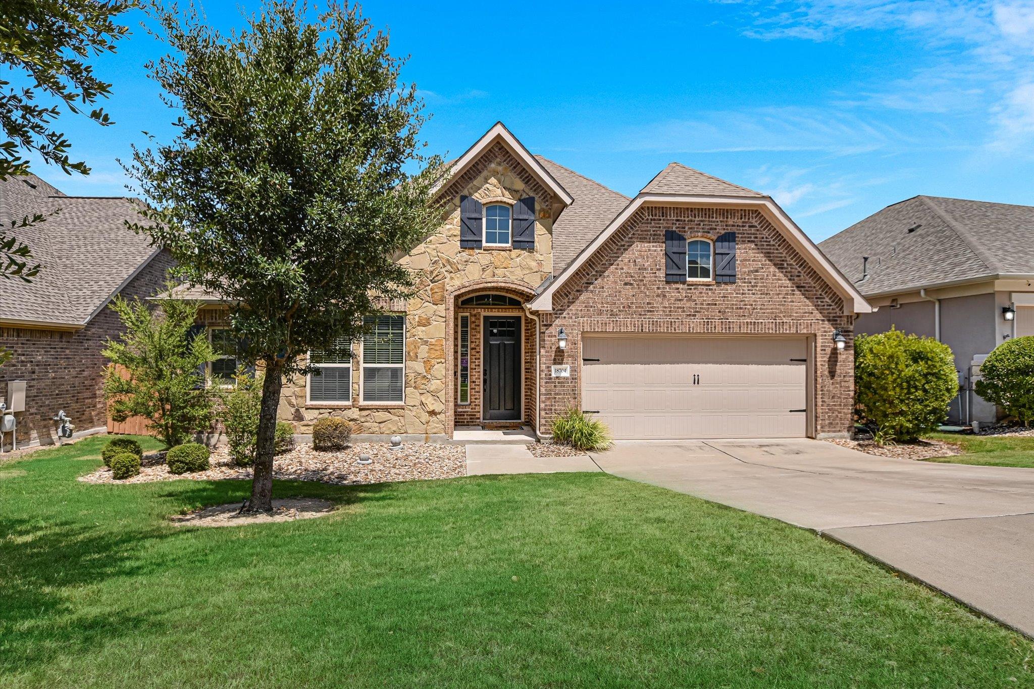 A classic brick and stone facade frames the entry