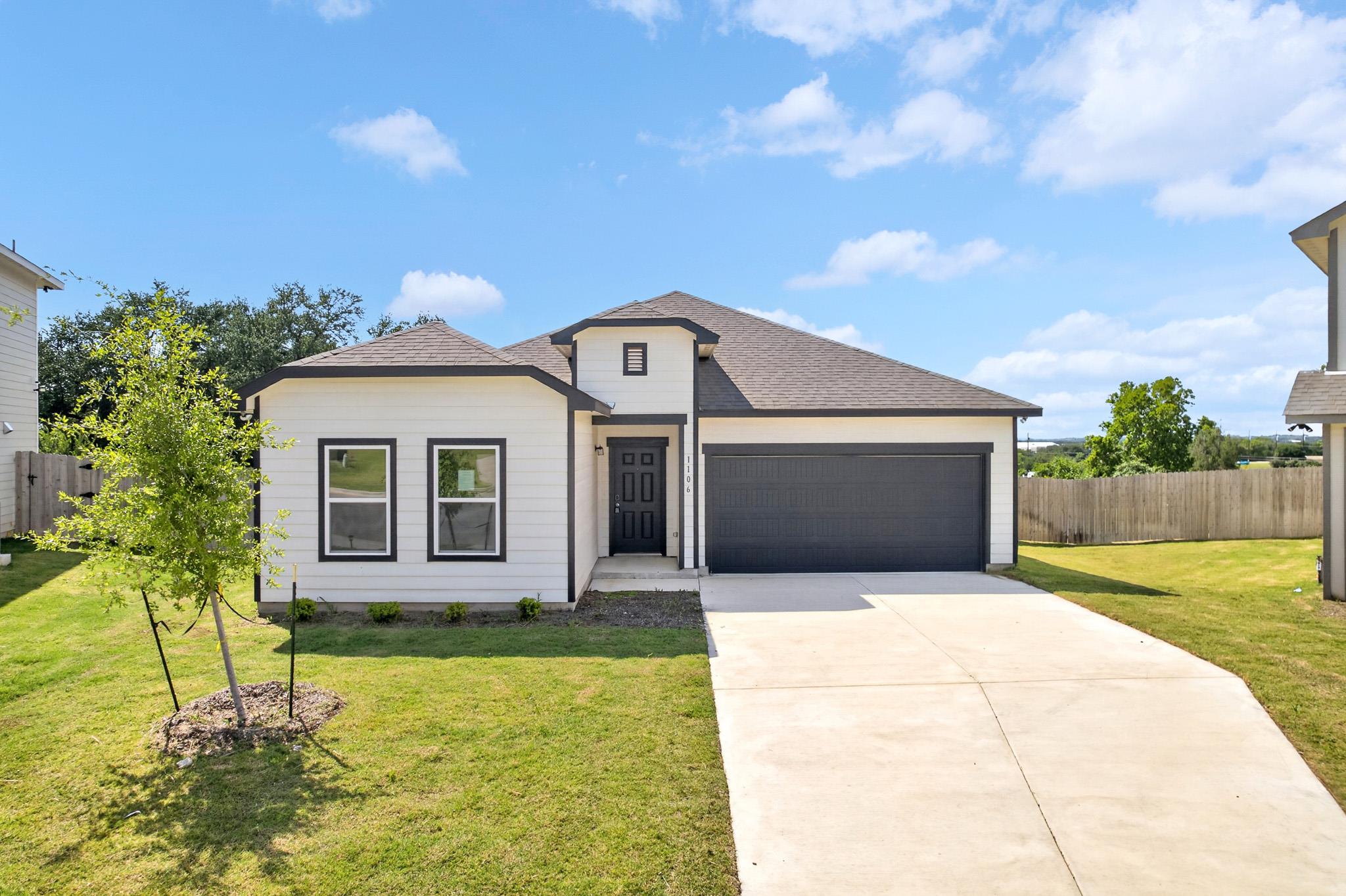 A pristine concrete driveway leads to the integra