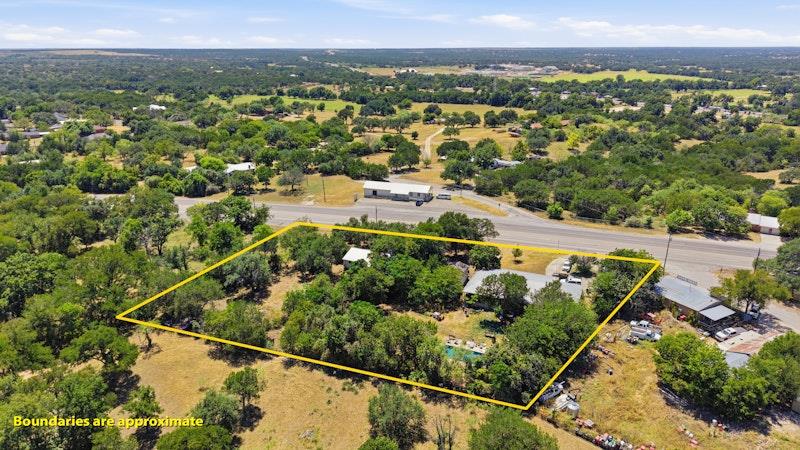 An aerial perspective showcases a wooded lot outl
