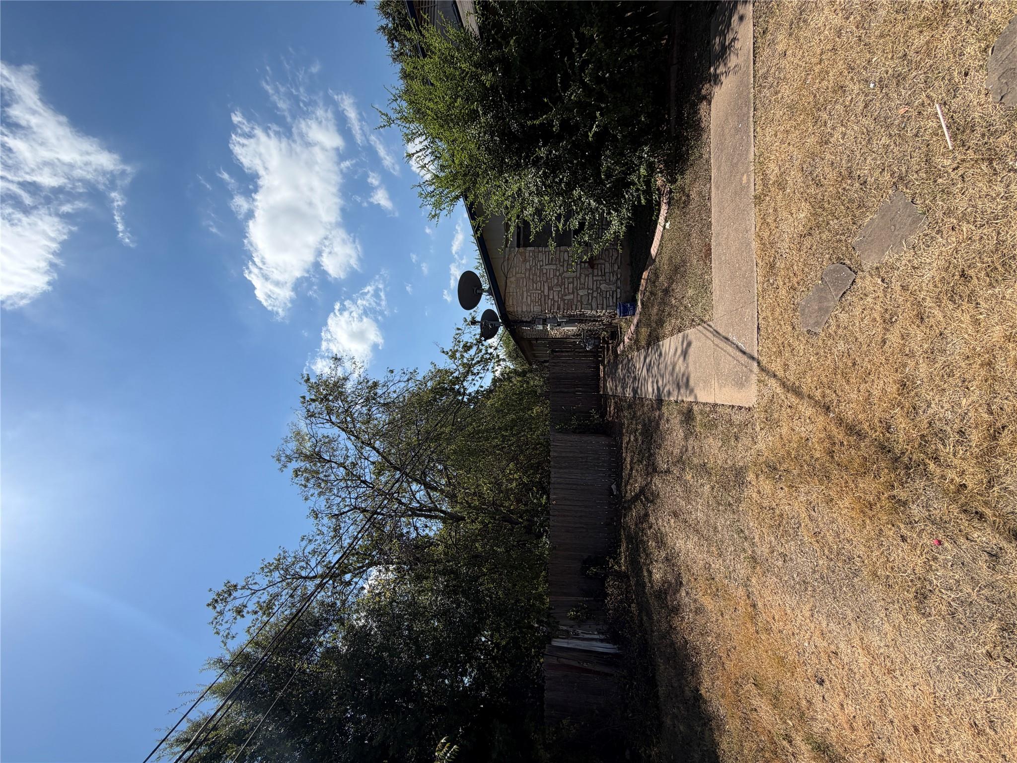 A concrete walkway leads alongside the textured s