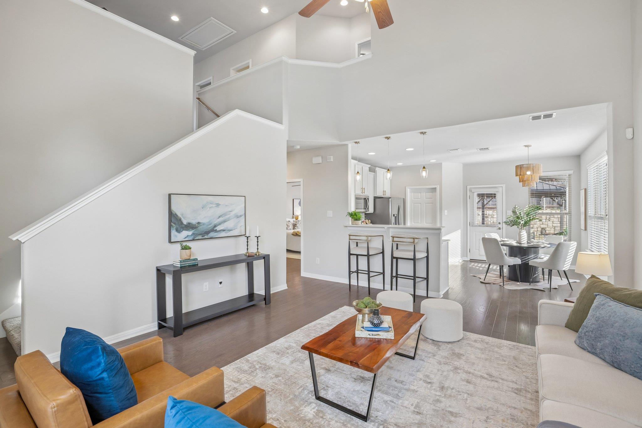 Soaring ceilings and dark wood floors define this