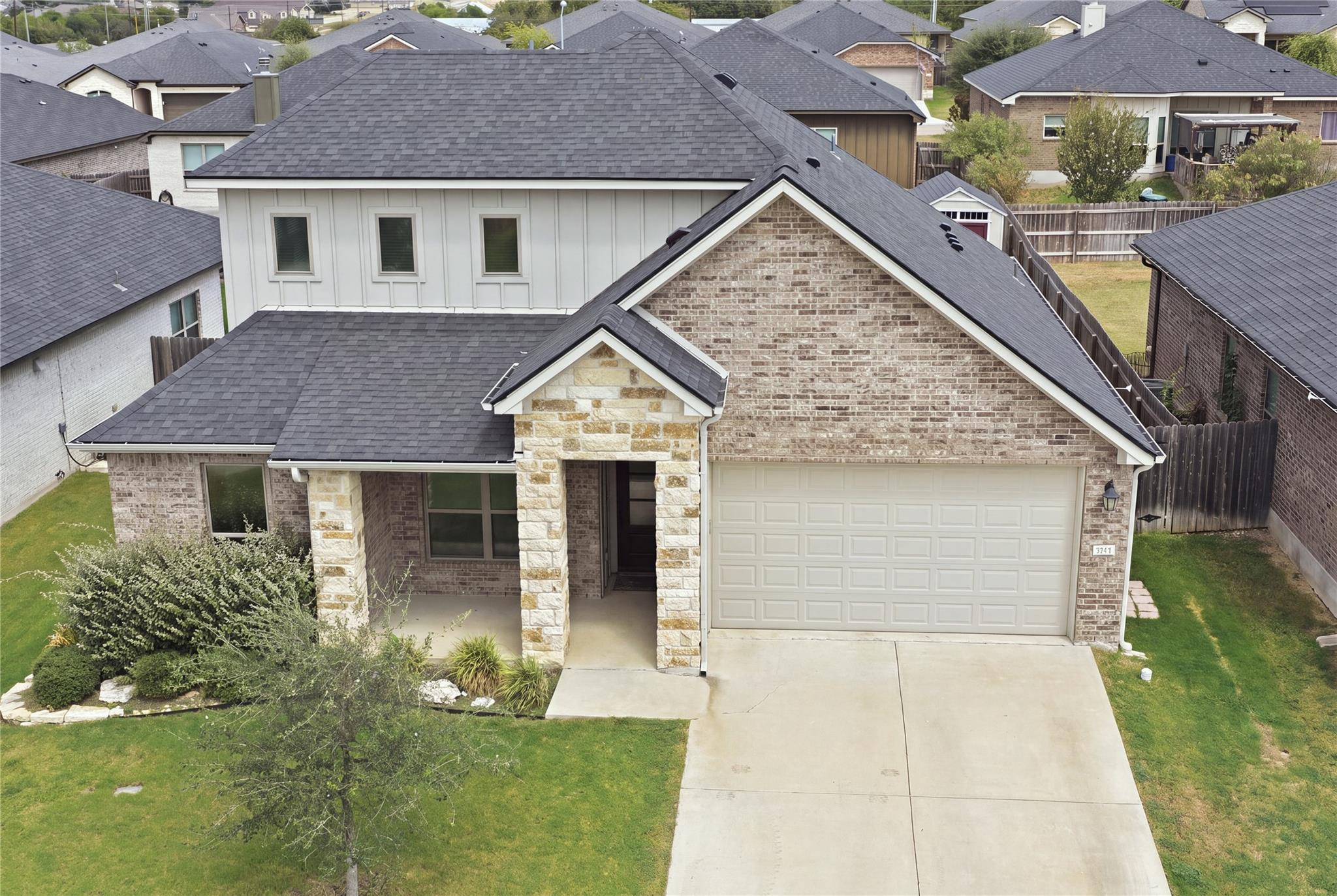 A striking combination of brick, stone, and board