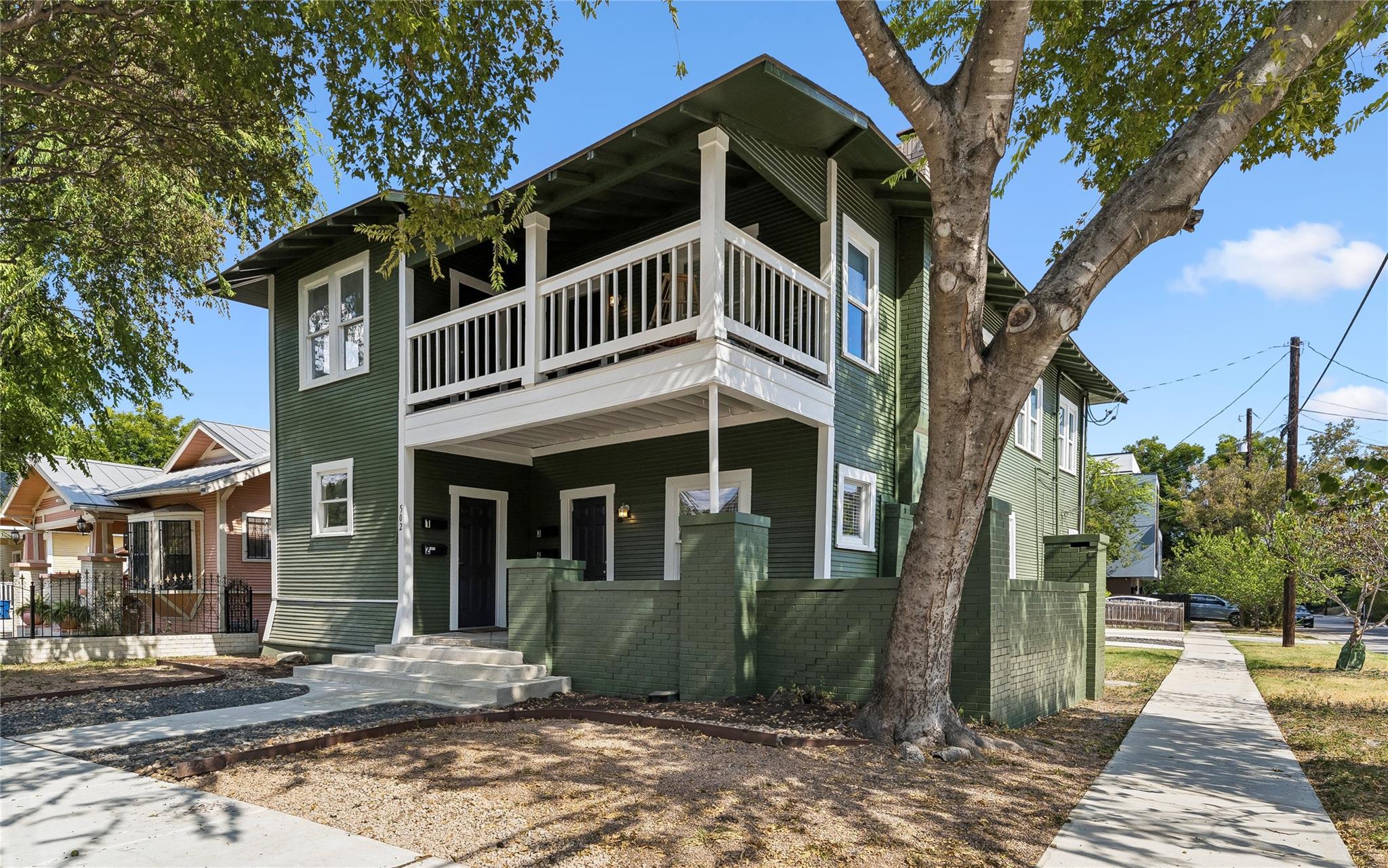 Mature trees shade a classic two-story exterior f