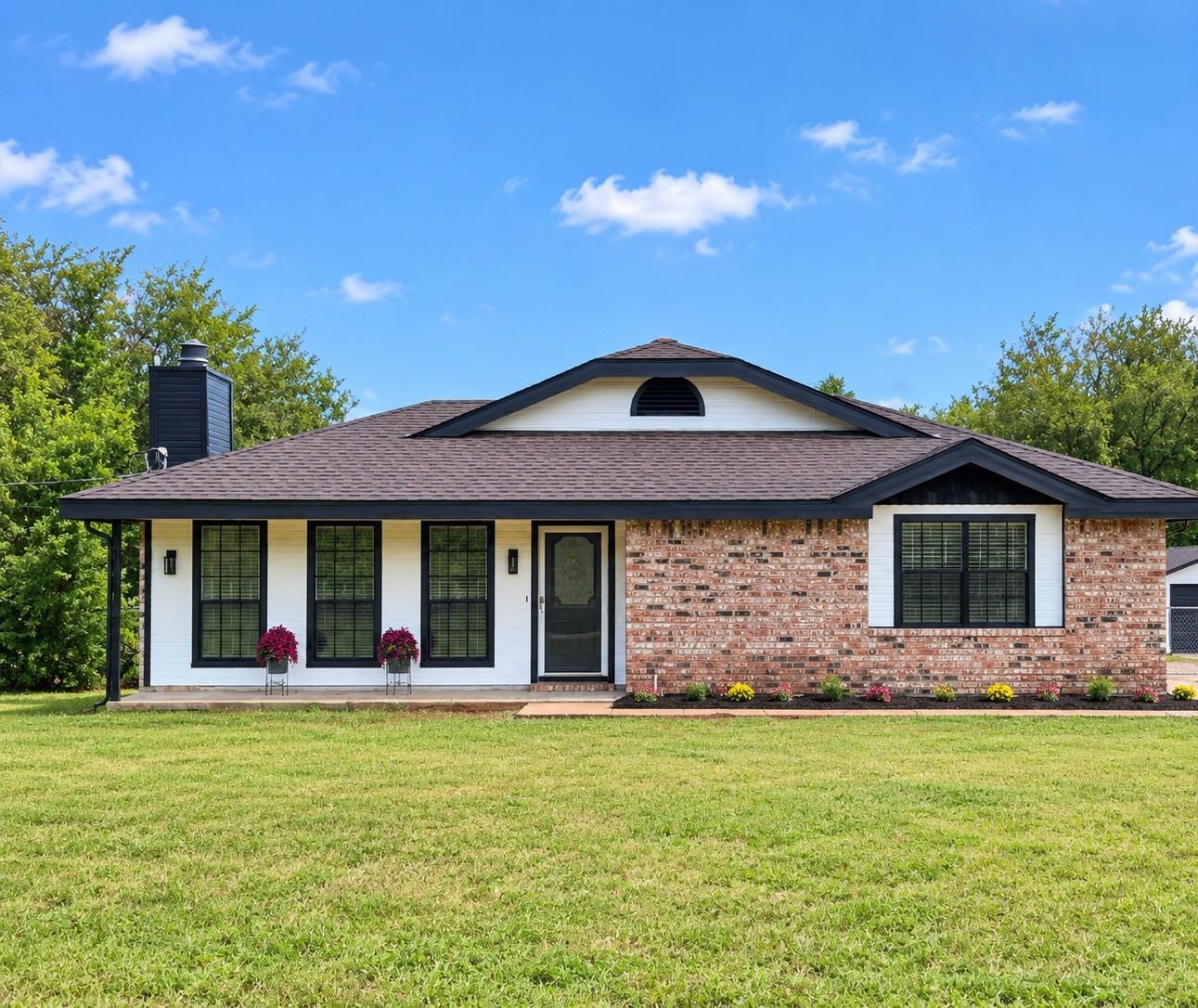 Classic brick and siding accents define the exter