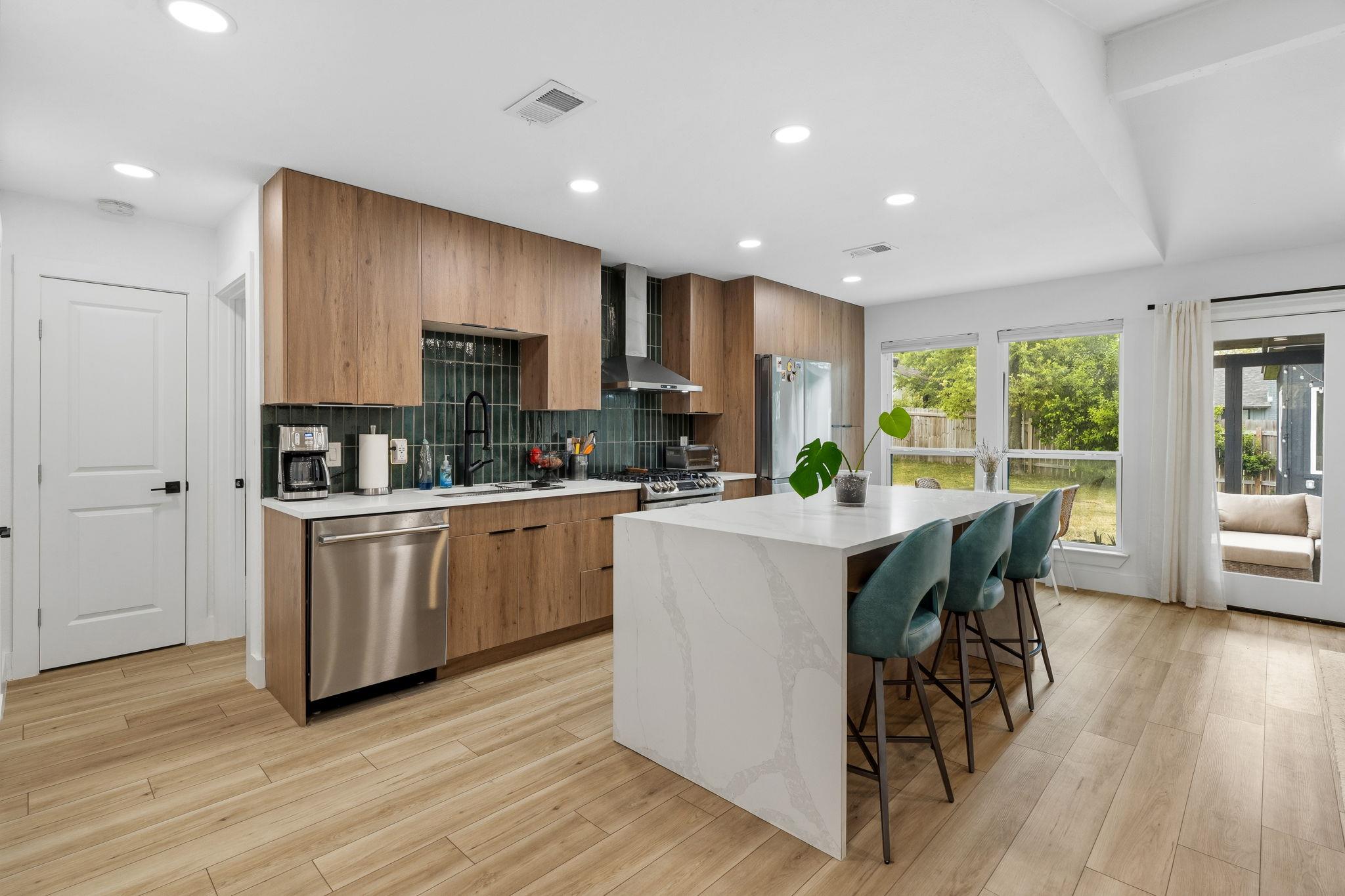 A spacious kitchen features warm wood cabinetry a