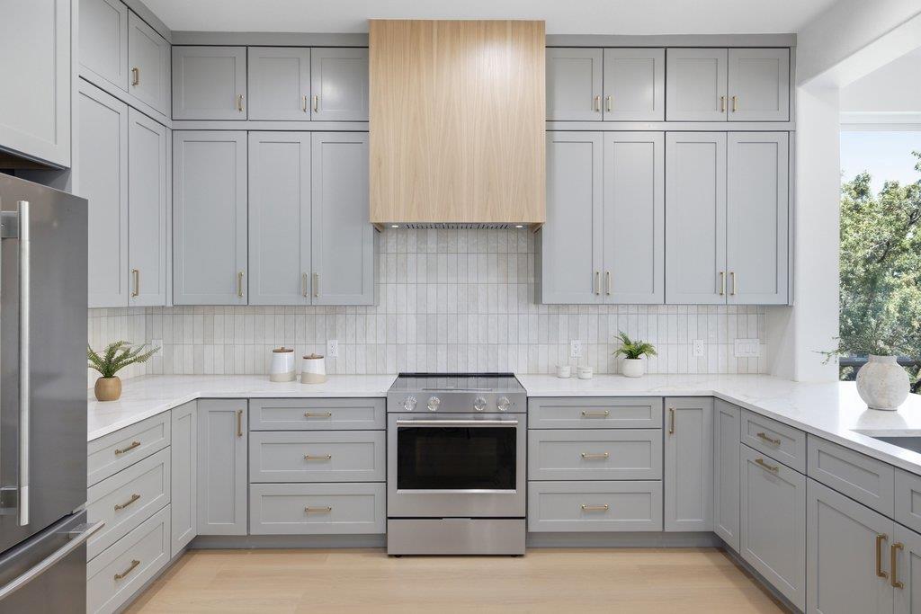 Modern cabinetry and clean countertops frame a ce