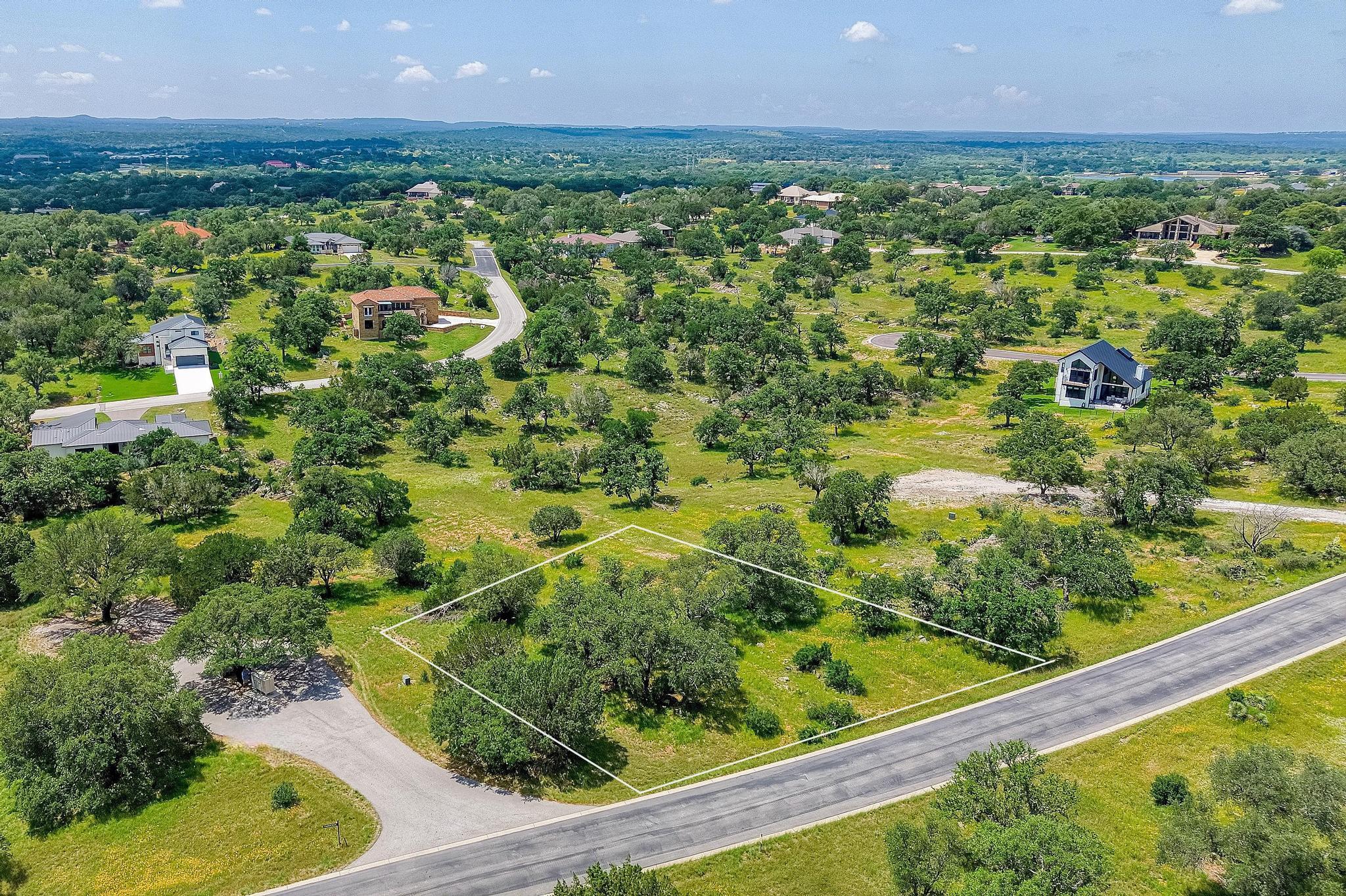 Mature trees dot this spacious building lot nestl