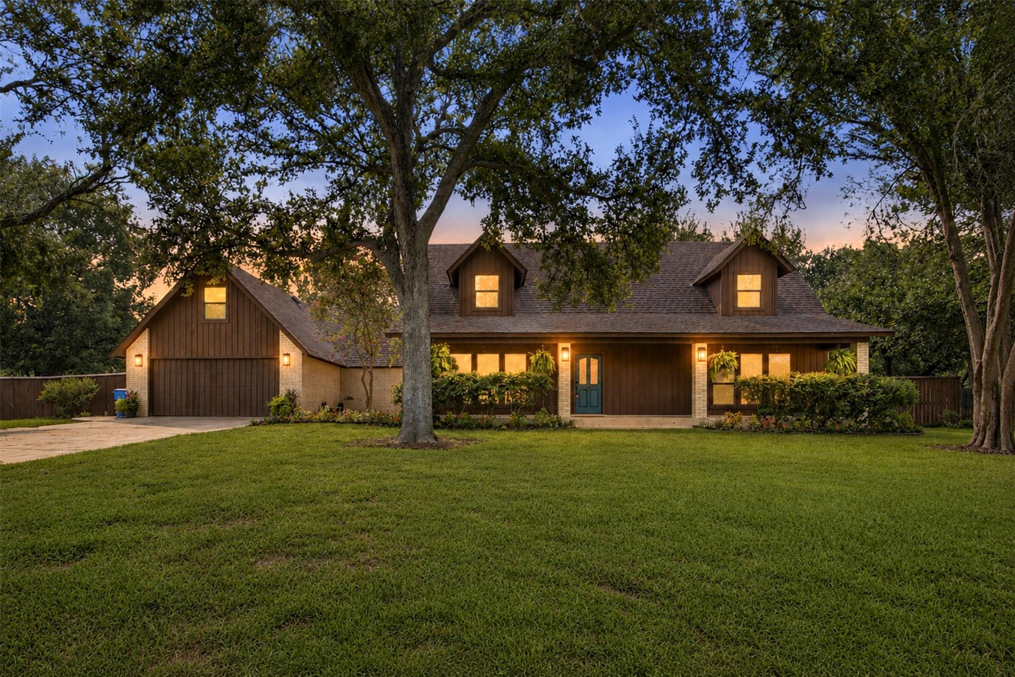 Mature trees shade a welcoming front elevation wi