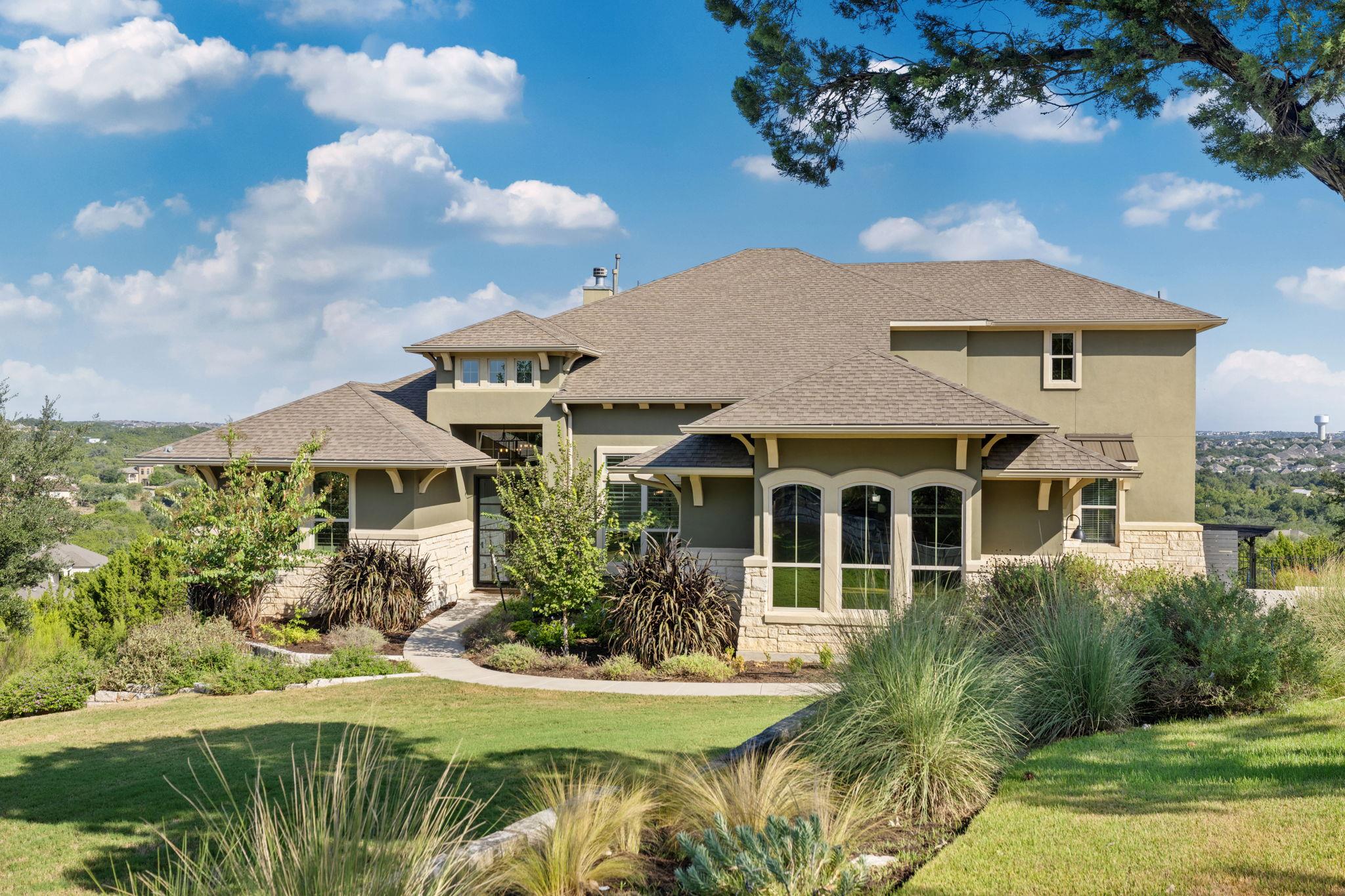 Manicured pathways wind toward a multi-level ston