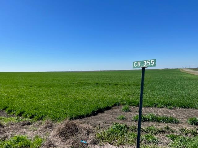 Vast green fields stretch toward the horizon unde