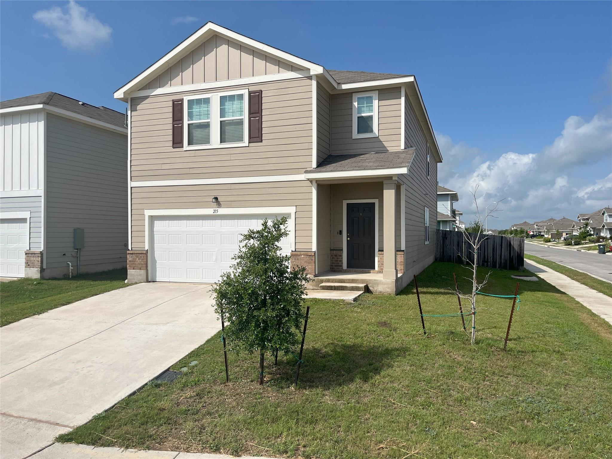 A classic two-story exterior boasts clean siding,