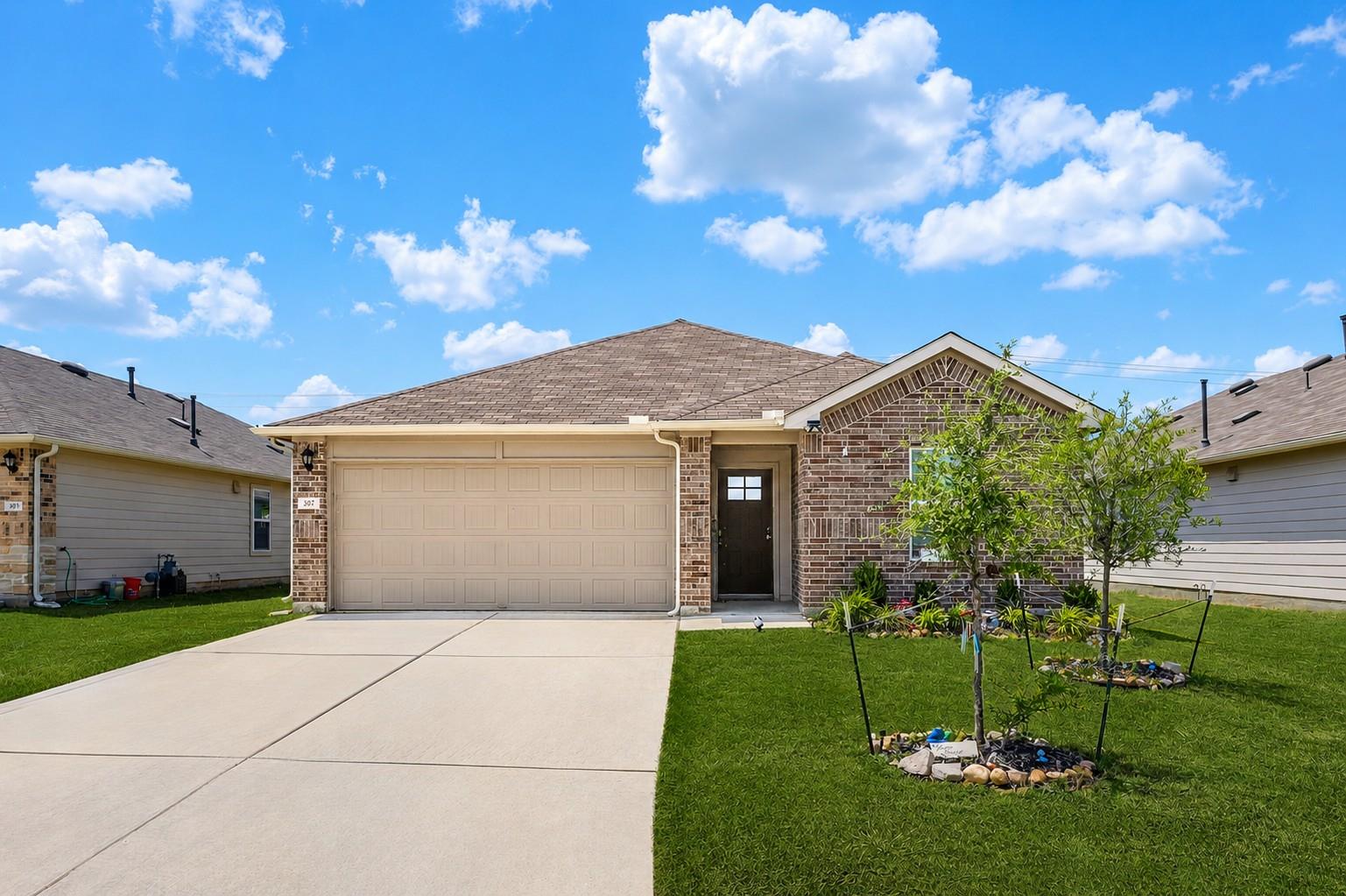 A classic brick exterior and a concrete driveway 