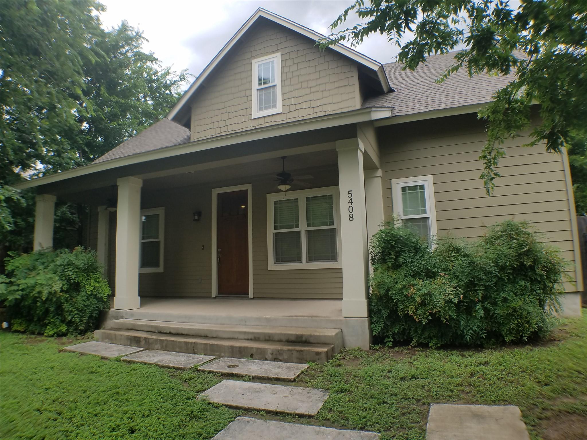 A welcoming front porch leads to the entrance of 