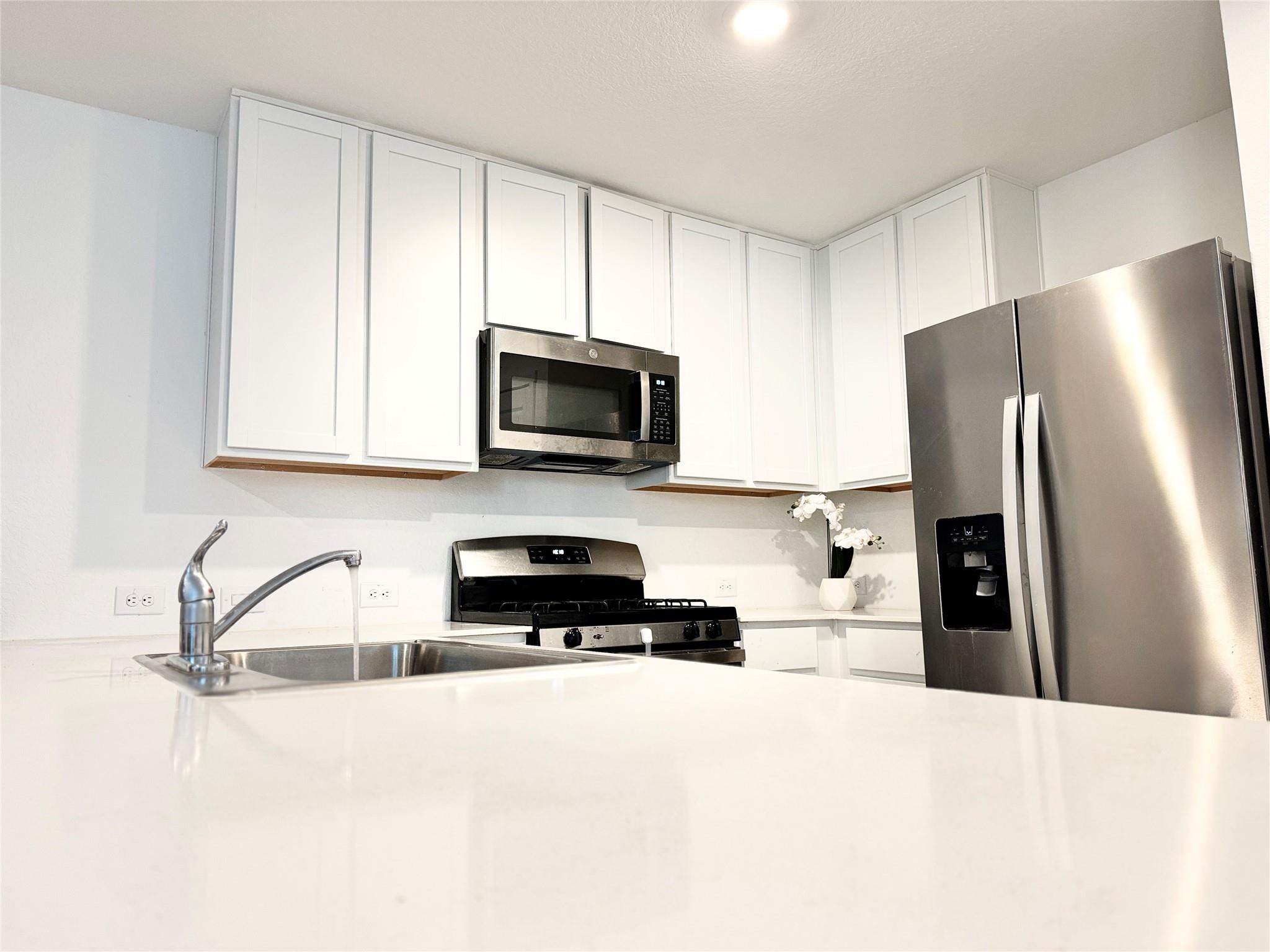 Sleek stone countertops complement classic shaker