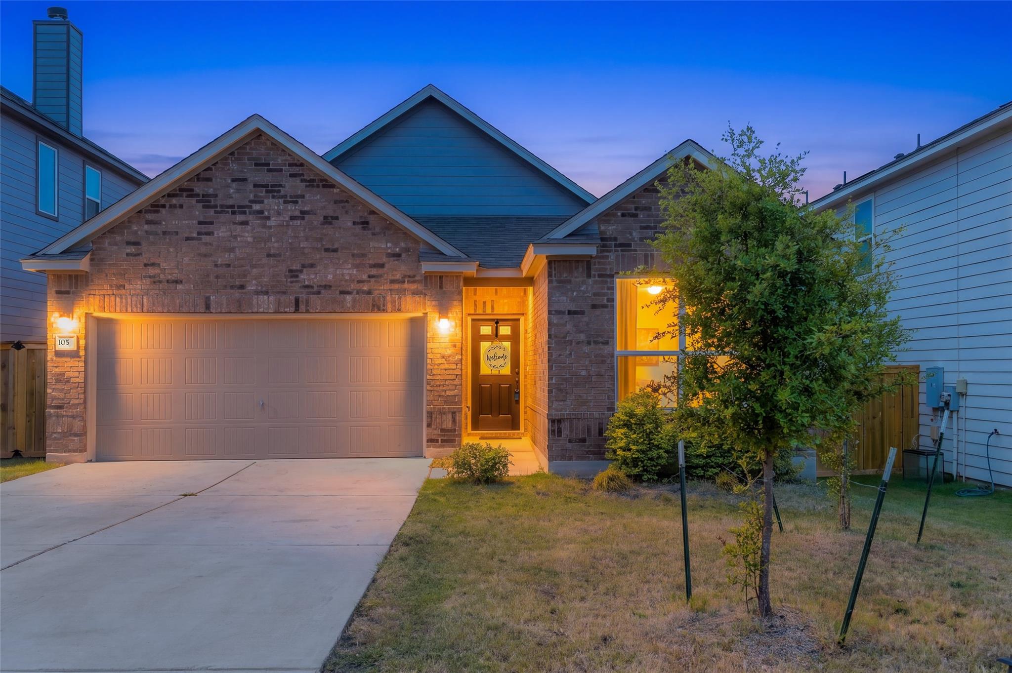 Warm exterior lights illuminate the classic brick