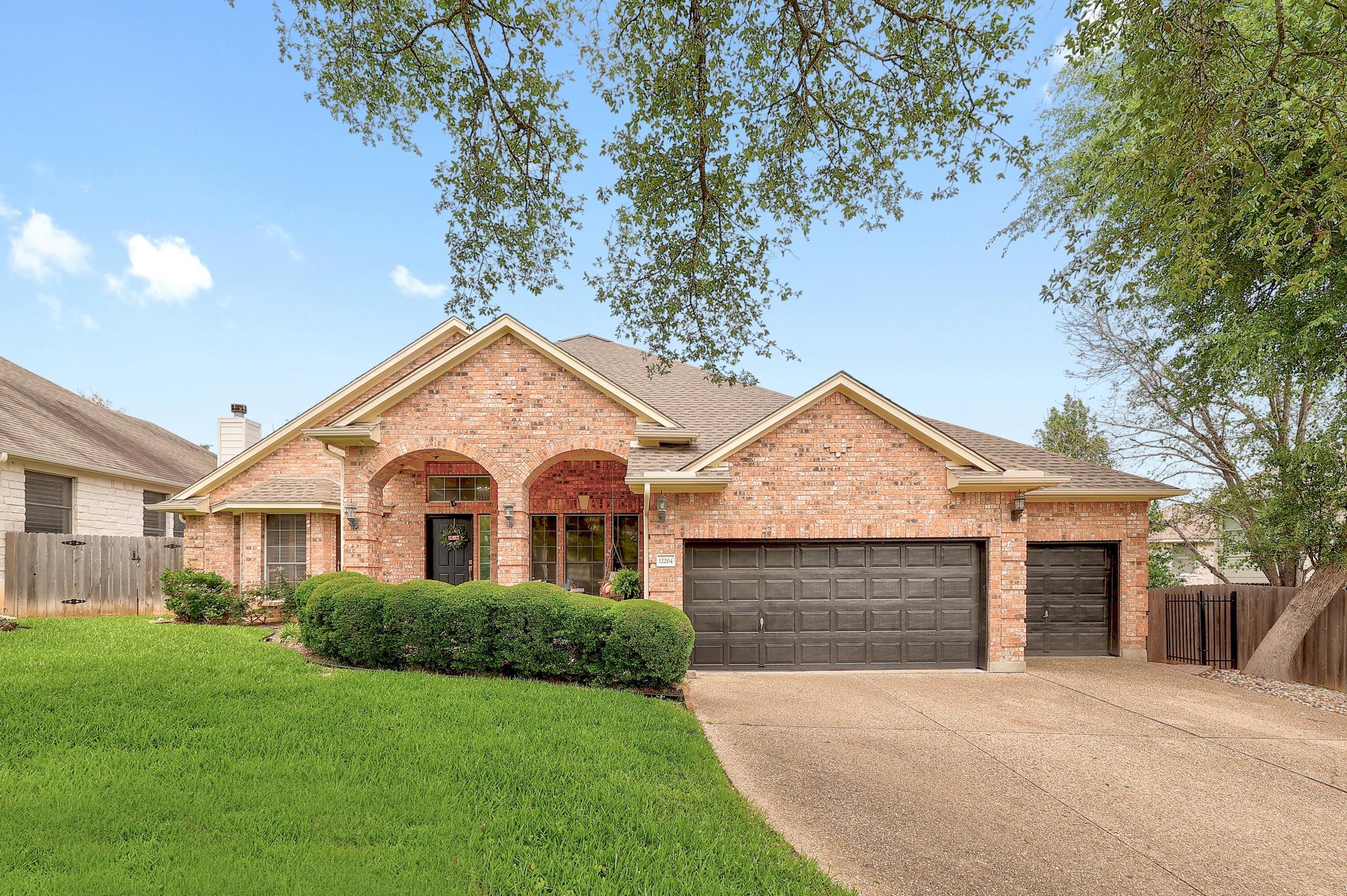 Traditional brick exterior featuring an arched en