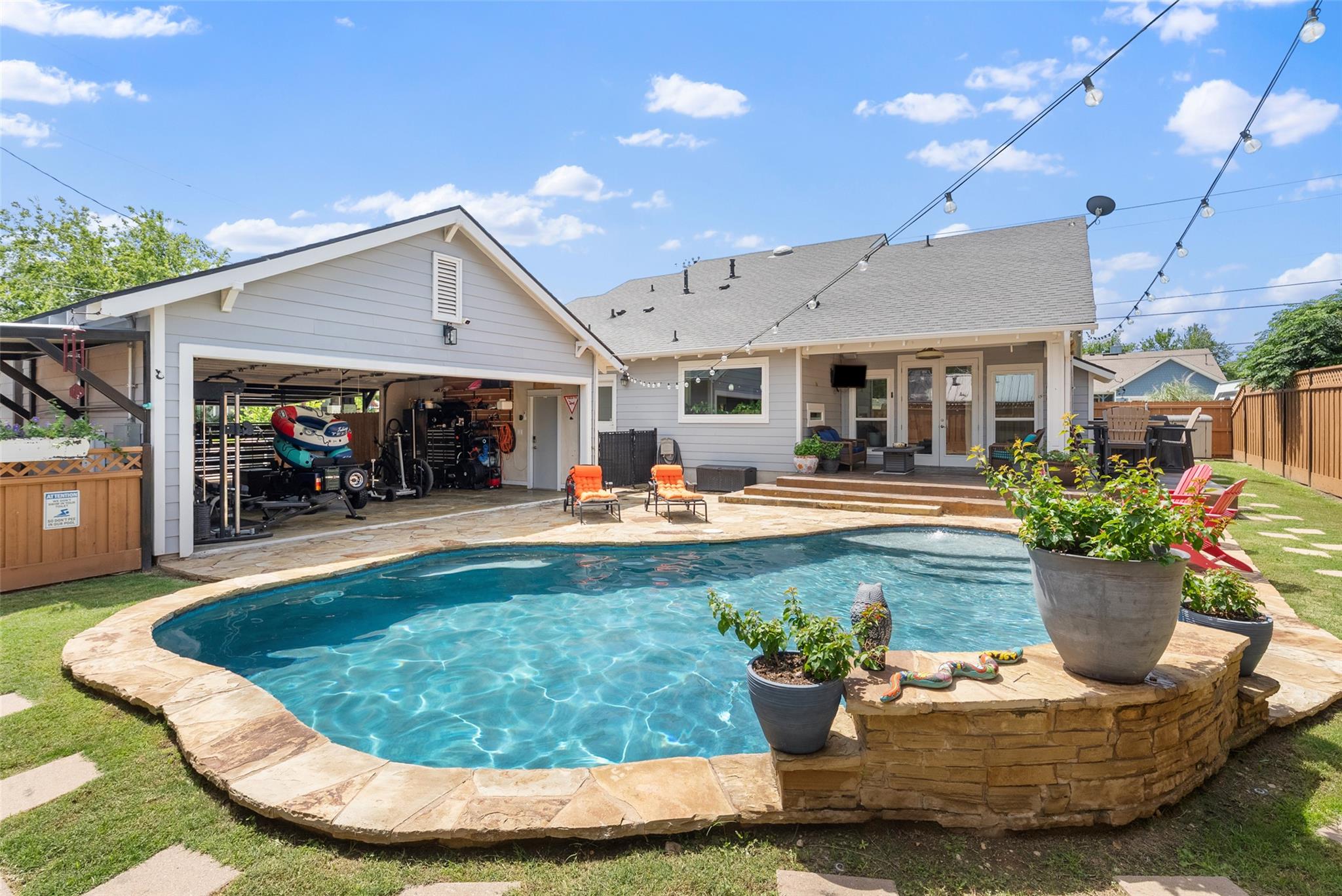 Backyard oasis with a refreshing pool, a spacious
