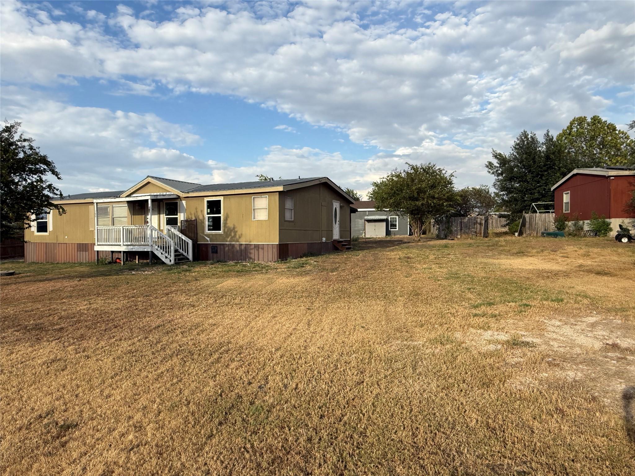 A spacious lawn surrounds this home featuring a f