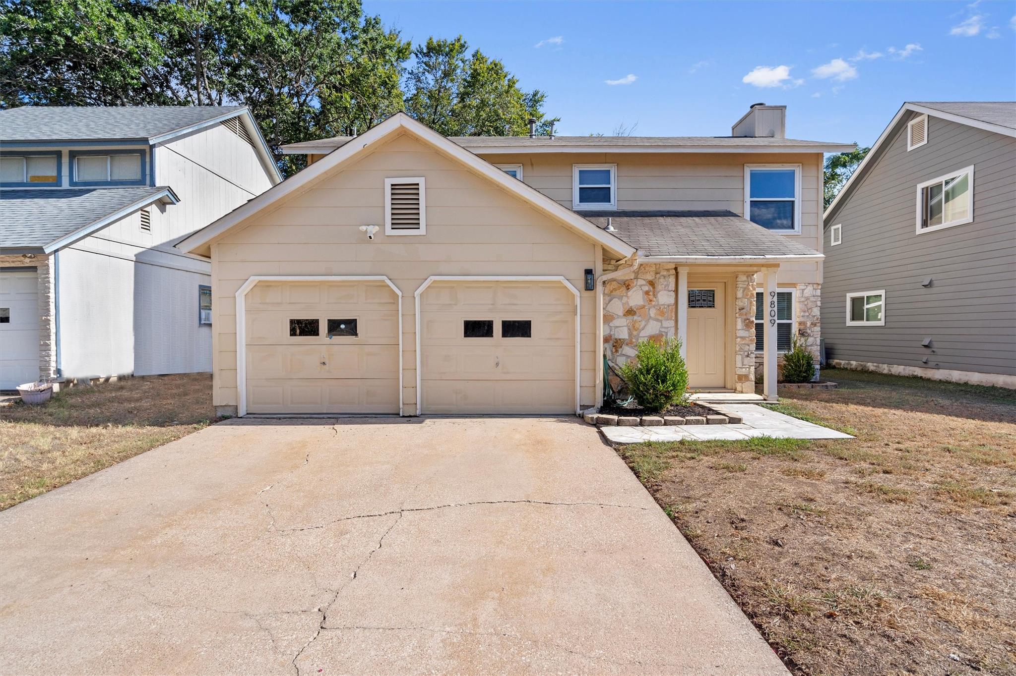 Traditional exterior design integrates a stone fa
