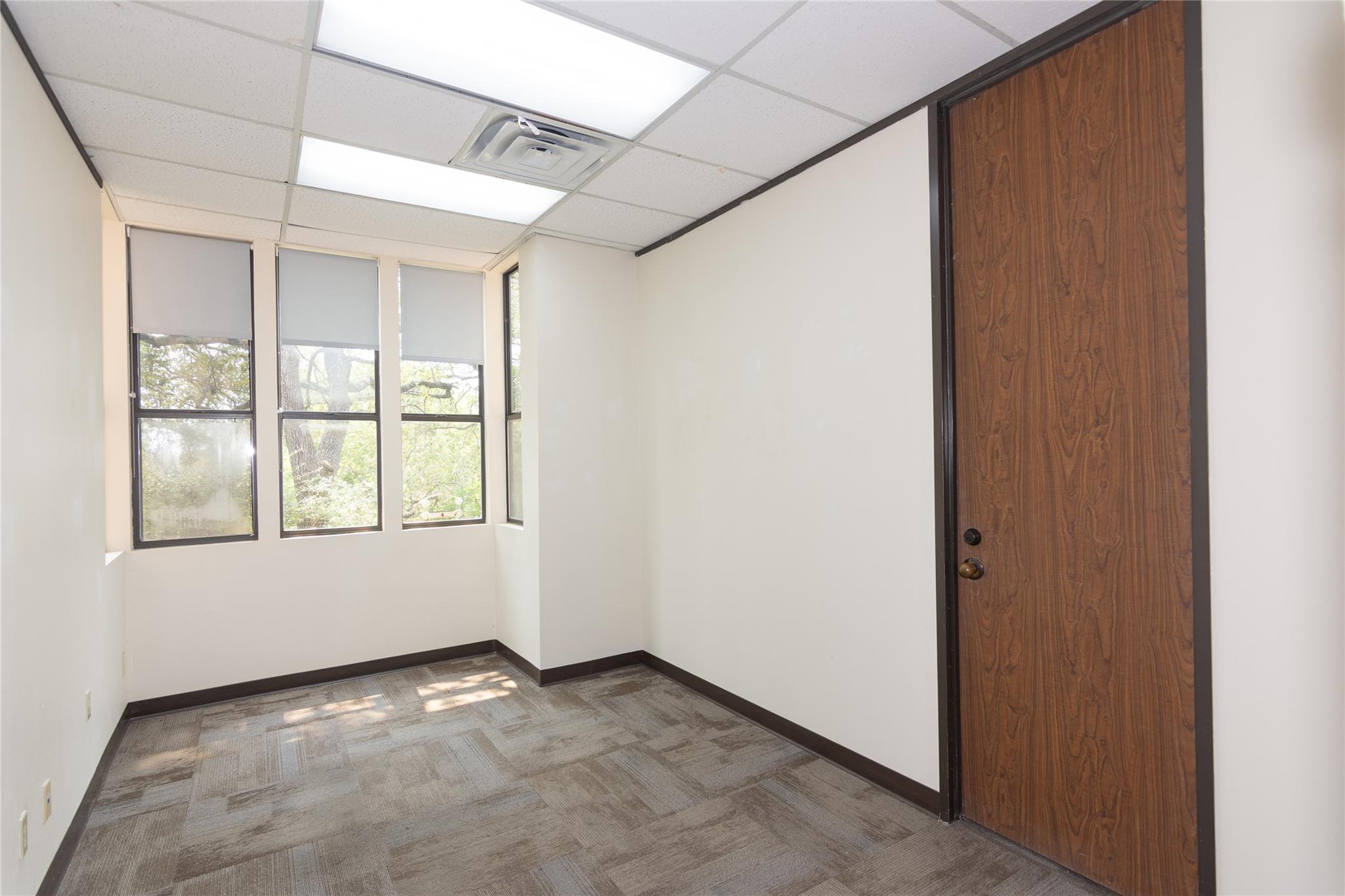 Functional office space featuring patterned carpe