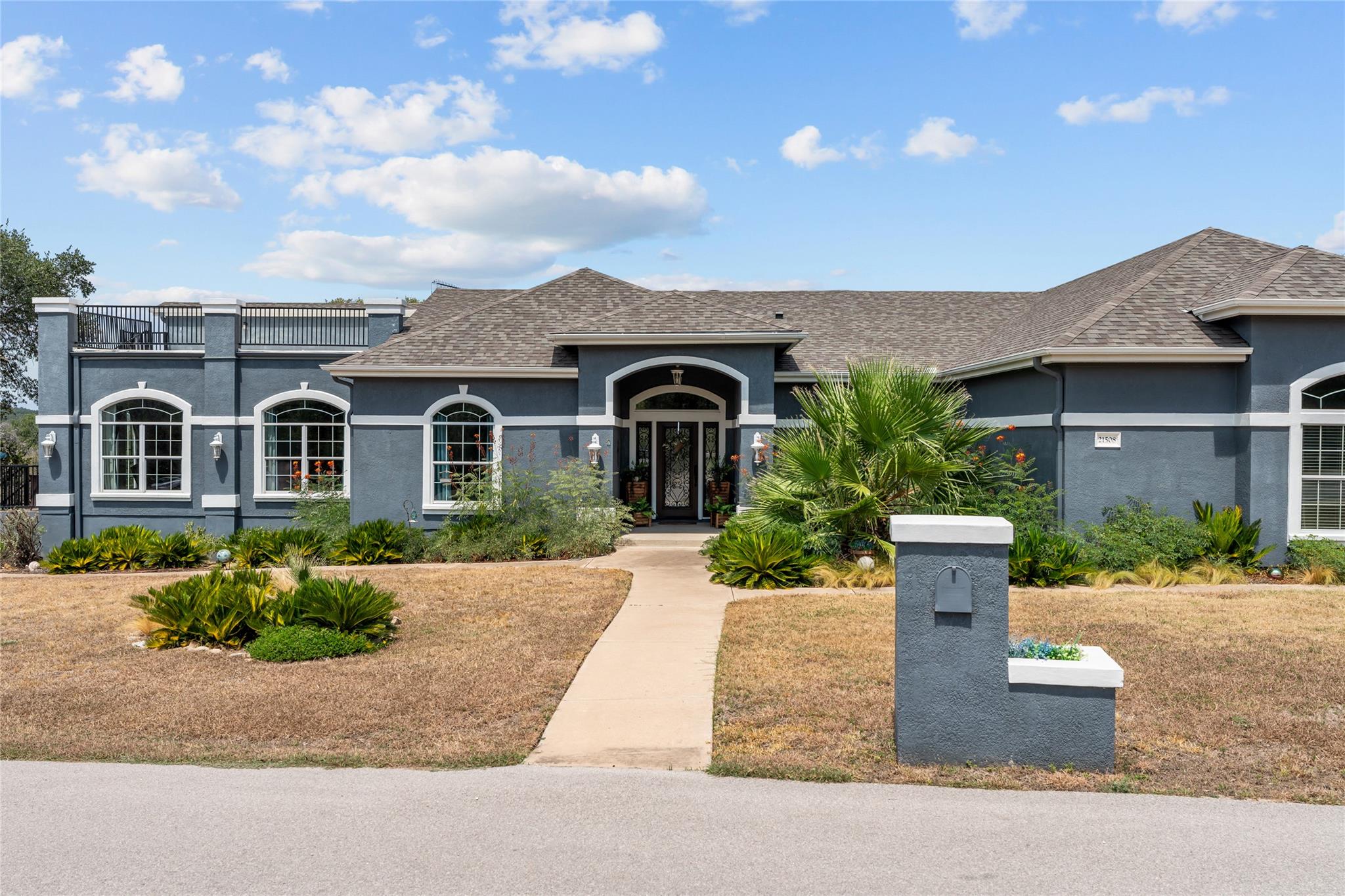 An arched entryway and symmetrical windows create