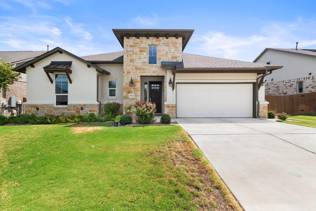 Natural stone accents and a manicured lawn define