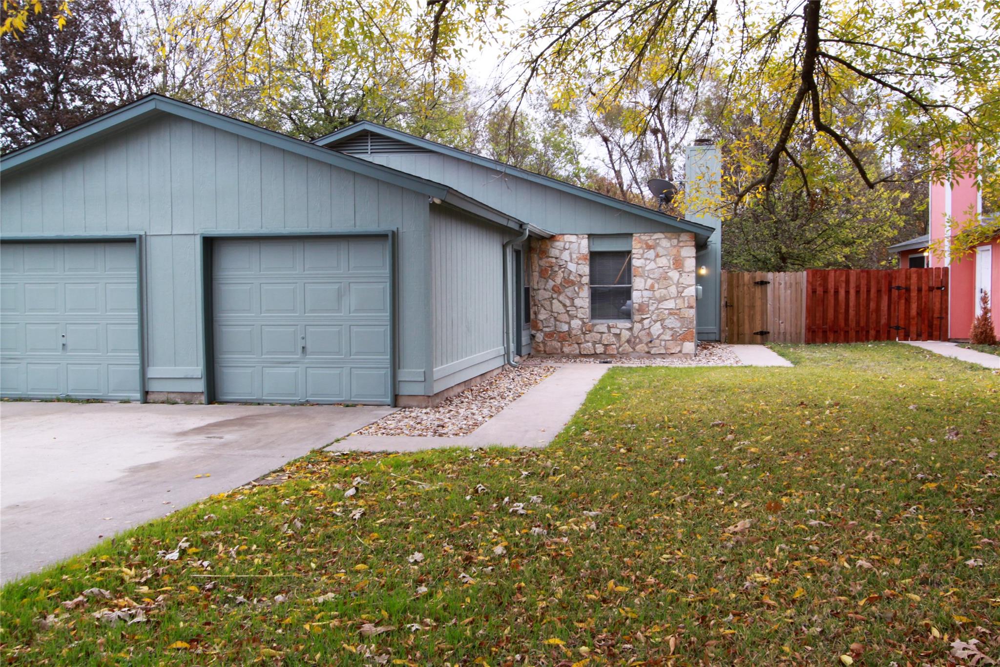 Mature trees shade a welcoming concrete driveway 