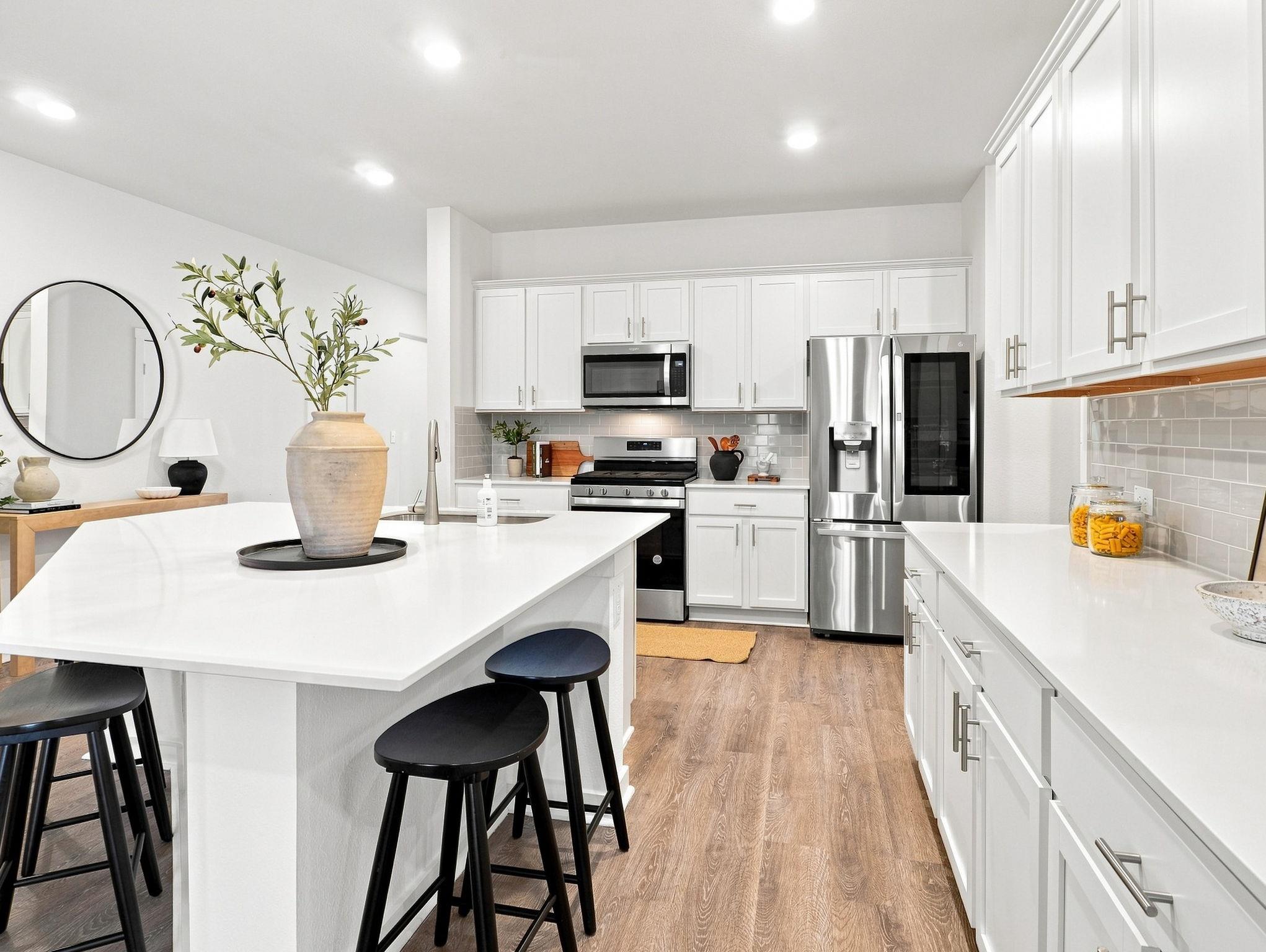 Sleek stone countertops and timeless cabinetry de