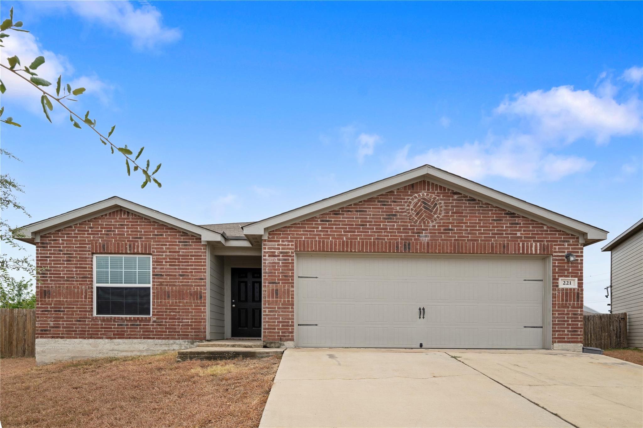 Classic brick exterior highlights a wide concrete
