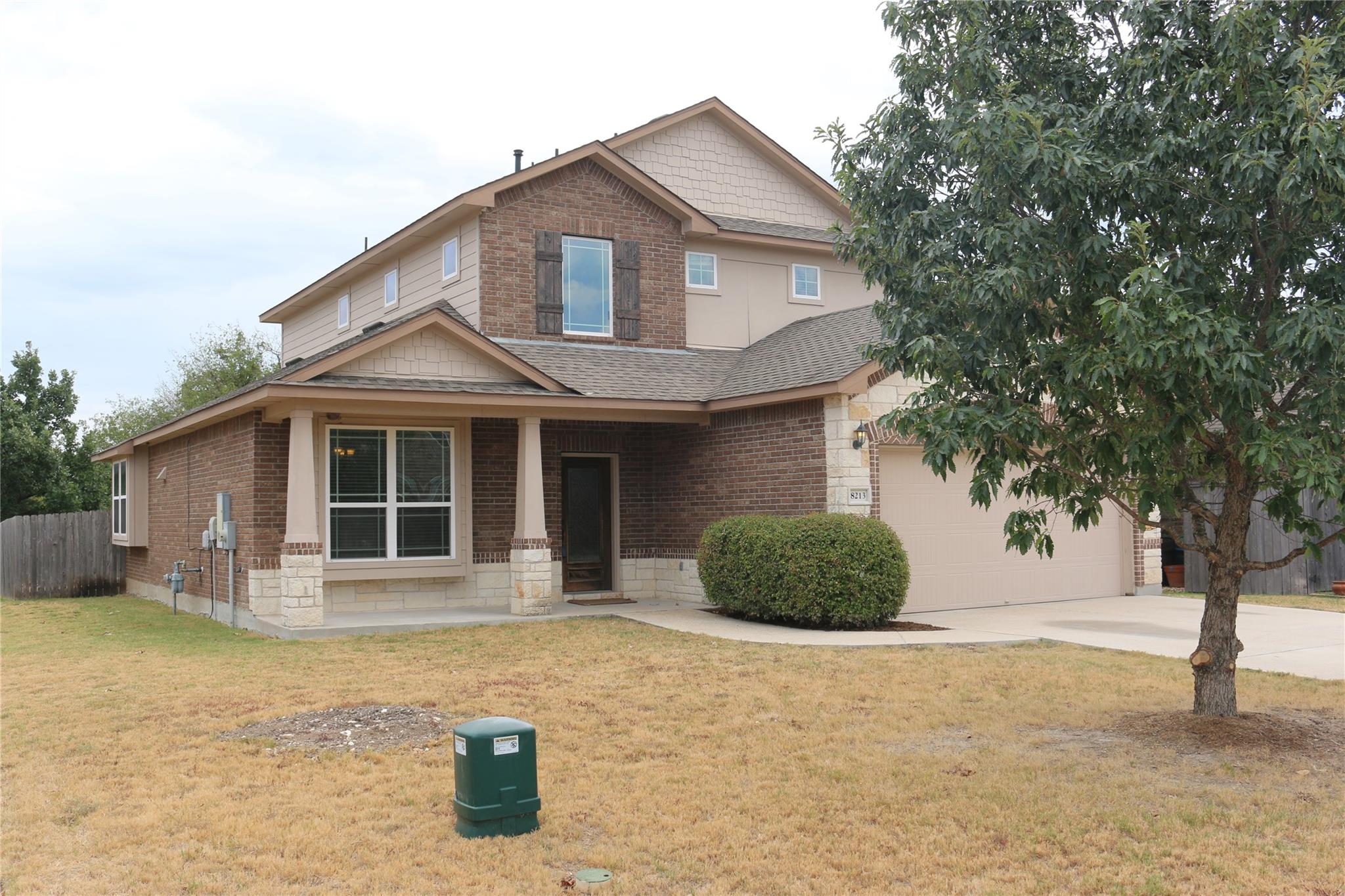 Brick and stone accents define this multi-level h