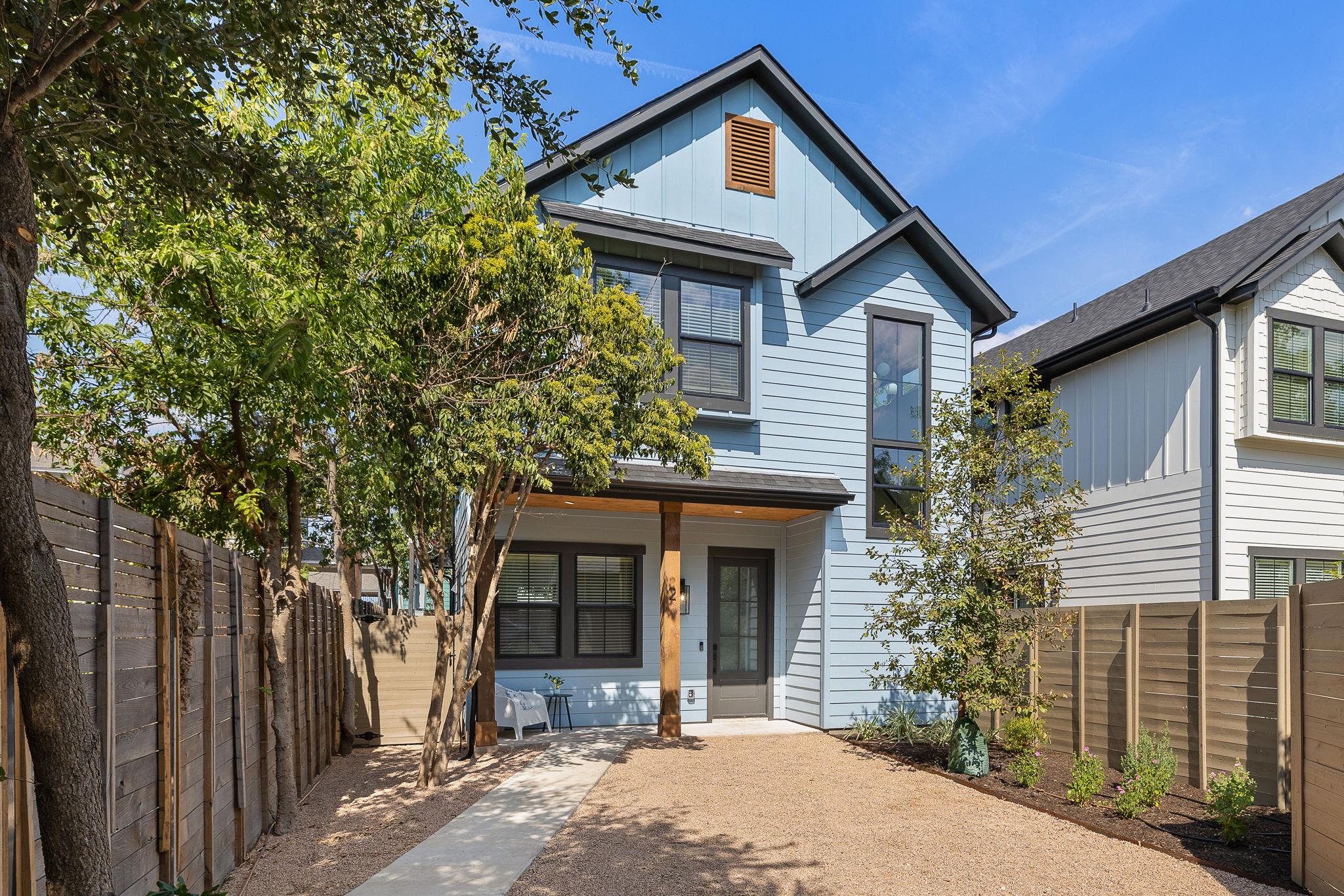 A modern two-story exterior highlights clean arch