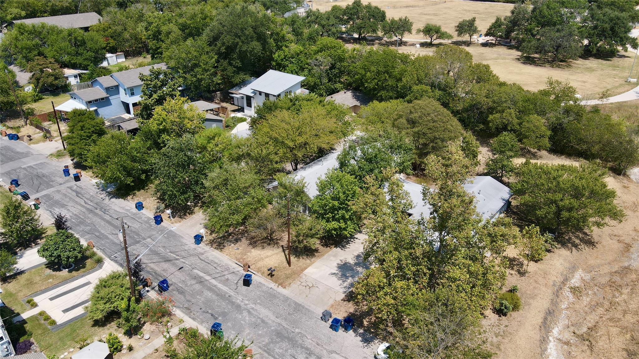 Aerial view showcases a wooded property nestled a